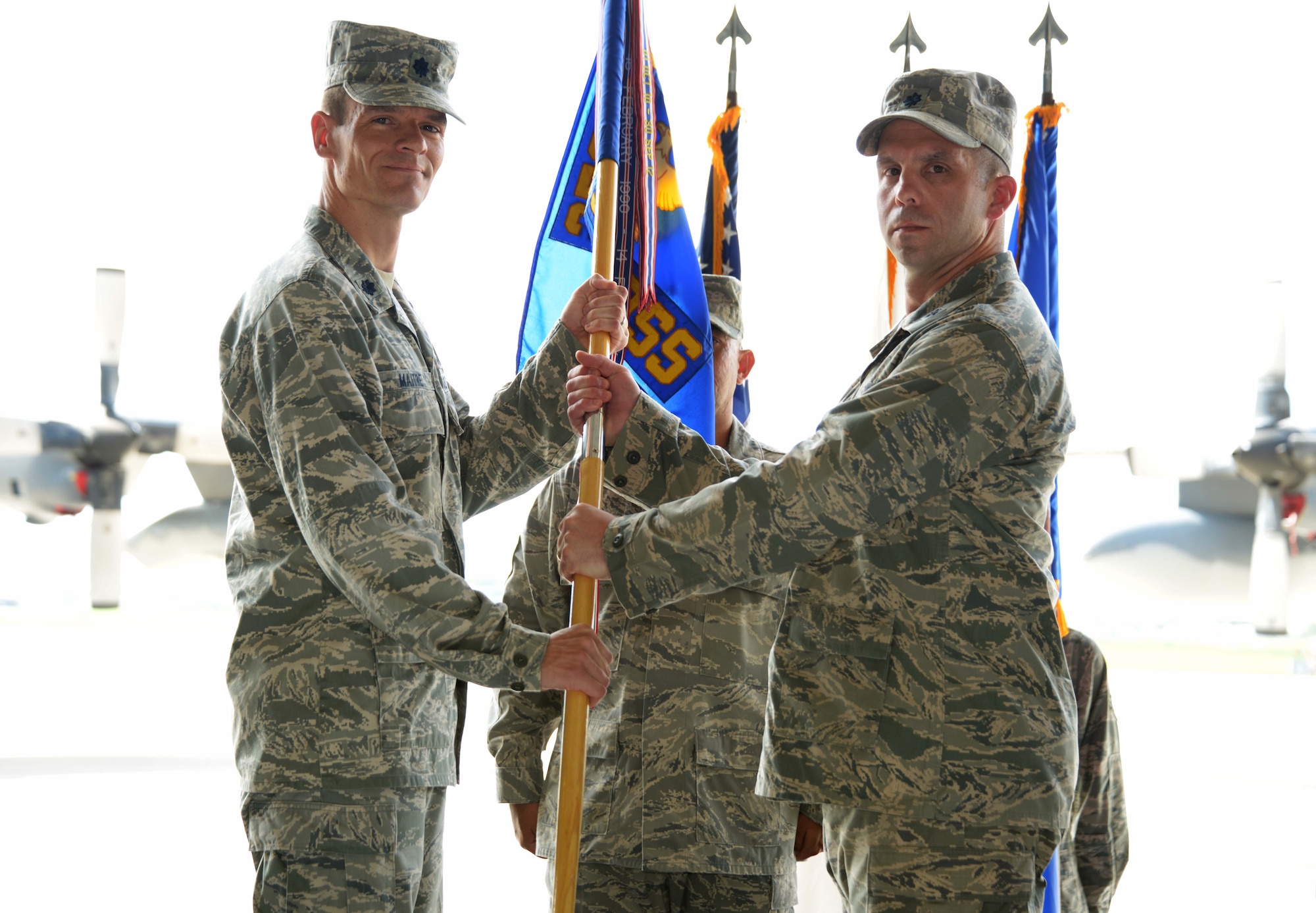 U.S. Air Force Lt. Col. Jay Pelka, 353rd Special Operations Support Squadron incoming commander, accepts the guidon from Lt. Col. Benjamin Maitre, 353rd Special Operations Group commander, during a change of command ceremony on Kadena Air Base, Japan, July 3, 2013.  The 353rd SOSS executes operations, planning, intelligence, and communications support functions for the 353rd SOG. (U.S. Air Force photo by Tech. Sgt. Kristine Dreyer/Released)