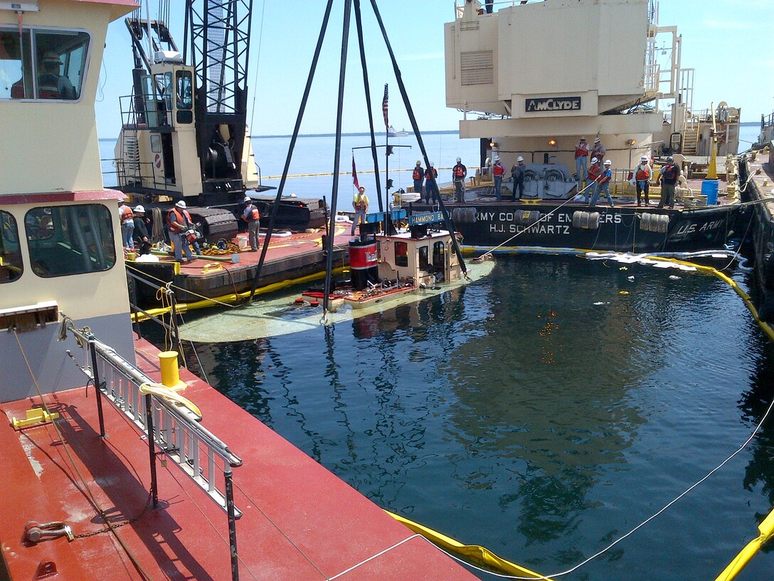 US Army Corps of Engineers Tug Hammond Bay is being lifted to the surface by the Corps' crane barge and vessel crews from the Soo Area Office in Sault Ste. Marie, Mich., July 3, 2013. The Hammond Bay unexpectedly sunk while being towed from Duluth, Minn., to Sault Ste. Marie July 1.