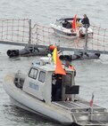 A Navy port security craft investigates a suspicious boat as part of a training scenario during Citadel Protect 2010(CP10).  CP10 is part of the Navy's regular training designed to asses the Navy's capability to protect waterborne assets against vessel borne and/or Improvised Explosive Device (IED) threats in Navy ports.  CP10 is a coordinated event between U.S. Fleet Forces and Commander, Navy Installations Command (CNIC).   