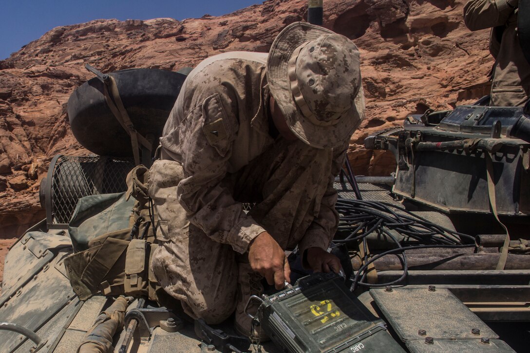 Lance Cpl. Tanner Ornduff, radio operator from Bloomfield, Iowa, assigned to Company K, Battalion Landing Team 3/2, 26th Marine Expeditionary Unit, sets up a AN/PRC 117F VHF radio on an amphibious assault vehicle during a training event as part of Exercise Eager Lion 2013 in Al Quweira, Jordan, June 17, 2013. Exercise Eager Lion 2013 is an annual, multinational exercise designed to strengthen military-to-military relationships and enhance security and stability in the region by responding to modern-day security scenarios.  The 26th MEU is deployed to the 5th Fleet area of responsibility as part of the Kearsarge Amphibious Ready Group. The 26th MEU operates continuously across the globe, providing the president and unified combatant commanders with a forward-deployed, sea-based quick reaction force. (U.S. Marine Corps photo by Cpl. Michael S. Lockett, 26th MEU Public Affairs)