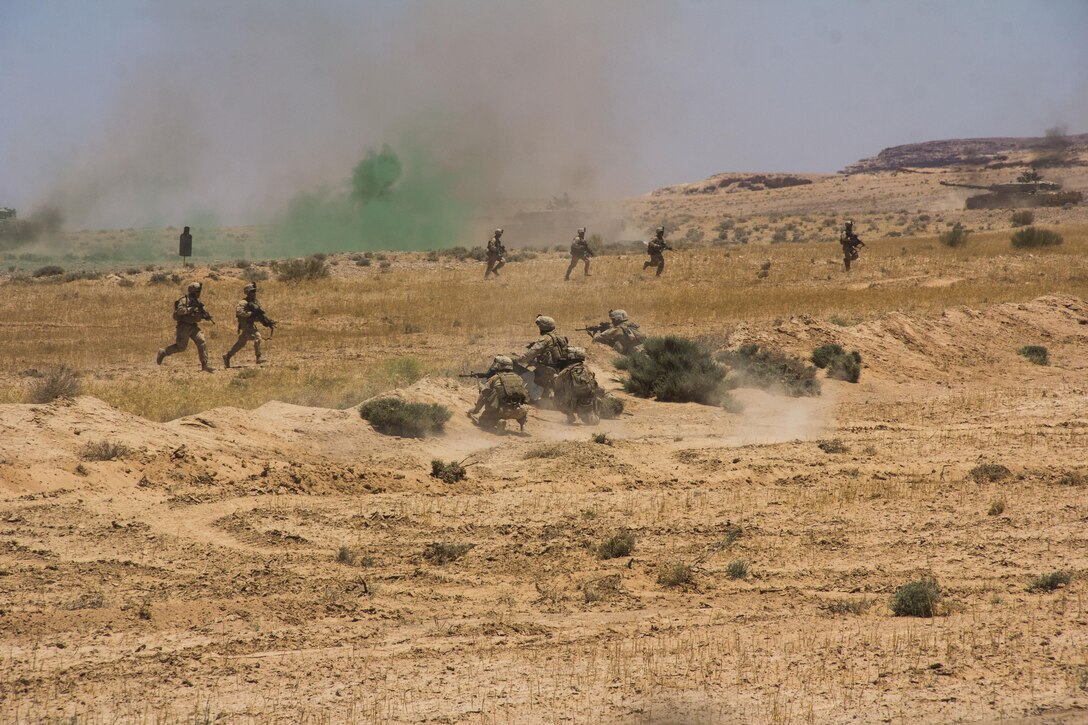 U.S. Marines of Company K, Battalion Landing Team 3/2, 26th Marine Expeditionary Unit (MEU), fall back to their amphibious assault vehicles after the assault on the objective during the Combined Arms Live Fire Exercise, the culminating event of Exercise Eager Lion 2013 in Al Quweira, Jordan, June 19, 2013. Exercise Eager Lion 2013 is an annual, multinational exercise designed to strengthen military-to-military relationships and enhance security and stability in the region by responding to modern-day security scenarios.  The 26th MEU is deployed to the 5th Fleet area of responsibility as part of the Kearsarge Amphibious Ready Group. The 26th MEU operates continuously across the globe, providing the president and unified combatant commanders with a forward-deployed, sea-based quick reaction force. (U.S. Marine Corps photo by Cpl. Michael S. Lockett, 26th MEU Public Affairs)
