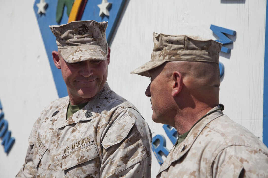 The 17th sergeant major of the Marine Corps, Sgt. Maj. Micheal P. Barrett, left, converses with Col. Austin E. Renforth, the commanding officer of Regimental Combat Team (RCT) 7 on Camp Leatherneck, Afghanistan, June 18, 2013. The Marines and Sailors of RCT-7 are deployed to Afghanistan in support of operation Enduring Freedom. (U.S. Marine Corps photo by Cpl. Alejandro Pena/Released)