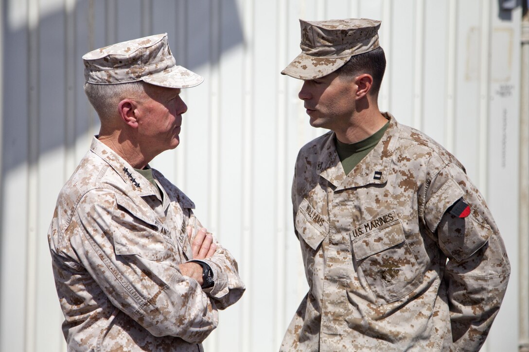 The 35th Commandant of the Marine Corps, Gen. James F. Amos, left, converses Capt. Brian S. Williams from Swansboro, N.C. and assigned to Fox Company, 2nd Battalion, 8th Marine Regiment (2/8) while visiting Camp Leatherneck, Afghanistan, June 18, 2013. The Marines of 2/8 are deployed to Afghanistan in support of operation Enduring Freedom. (U.S. Marine Corps photo by Cpl. Alejandro Pena/Released)