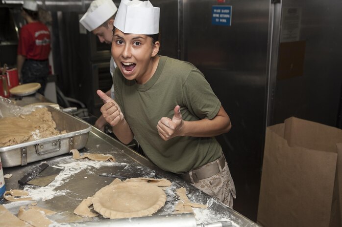 Lance Cpl. Teena M. Sifuentez , a food service specialist with Marine Medium Tiltrotor Squadron 265 (Reinforced), 31st Marine Expeditionary Unit, shows her excitement after finishing a blueberry pie here, June 28. An integrated team of Marines and Sailors work tirelessly each day to prepare more than 1,500 servings of home-style desserts for the four meals each day. The 31st MEU is the only continuously forward deployed MEU and is the Marine Corps’ force in readiness in the Asia-Pacific region.