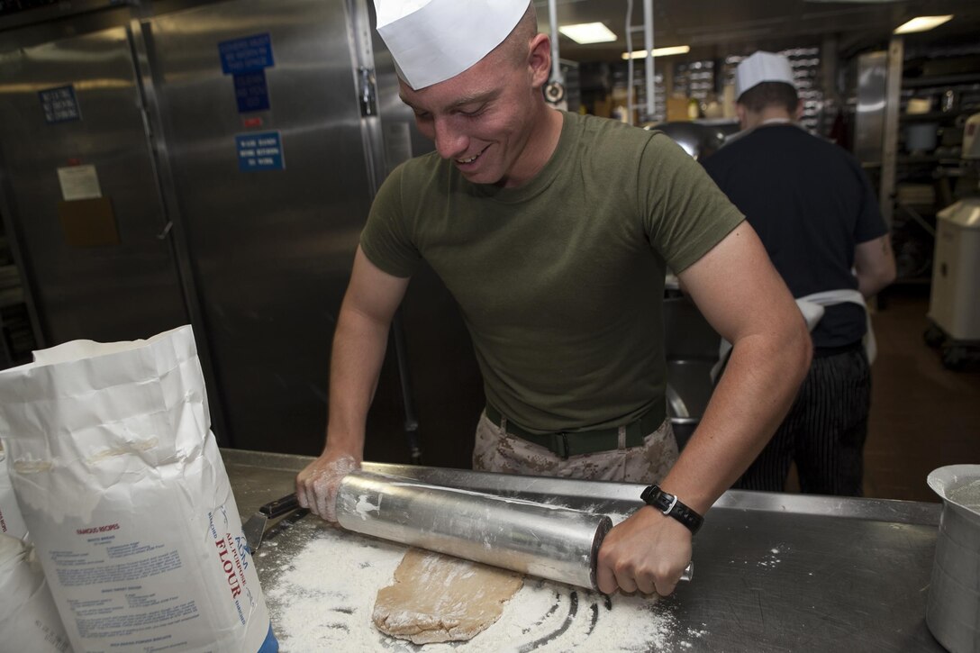 A Marine rolls dough for a blueberry pie in the ship’s bake shop here, June 28. An integrated team of Marines and Sailors work tirelessly each day to prepare more than 1,500 servings of home-style desserts for the four meals each day. The 31st MEU is the only continuously forward-deployed MEU and the Marine Corps’ force in readiness in the Asia-Pacific region.