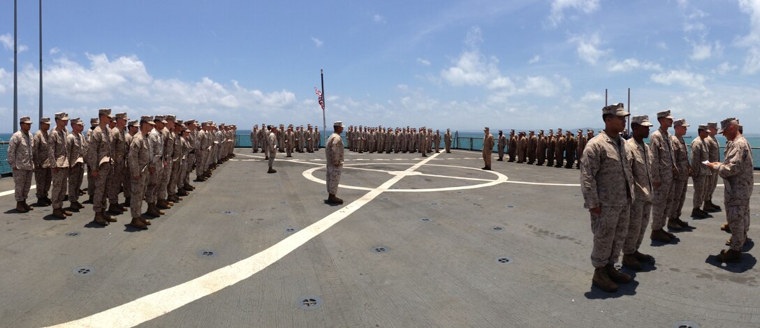 Marines and Sailors of Company G., Battalion Landing Team 2nd Battalion, 4th Marines, 31st Marine Expeditionary Unit, stand in formation as the description of the Fleet Marine Force pin is read during a ceremony here, June 28. Six corpsmen of Co. G. received their FMF pins following nearly a year of studying and testing. The pin signifies the corpsmen’s knowledge of Marine Corps history, traditions and operations. The 31st MEU is the only forward-deployed MEU and is the Marine Corps’ force in readiness in the Asia-Pacific region.