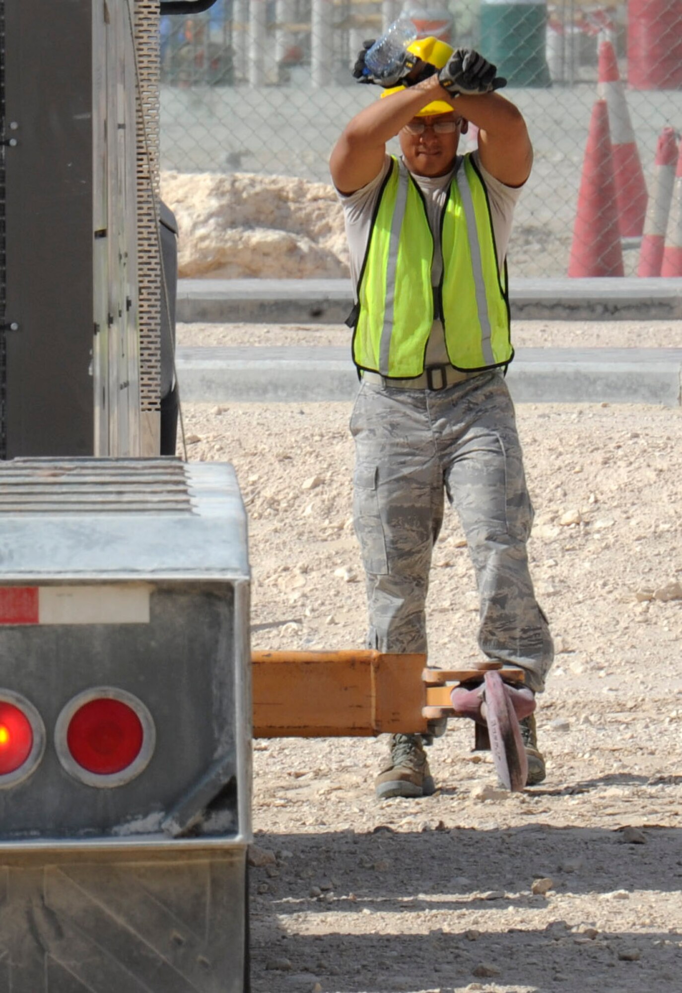 Staff Sgt. Ephraim Advincula signals a truck transporting an air conditioning unit at the 379th Air Expeditionary Wing in Southwest Asia, June 28, 2013. The 379th Expeditionary Civil Engineer Squadron horizontal heavy repair shop supports construction projects throughout the 379th AEW. Advincula is a 379th ECES heavy repair craftsman deployed from Ramstein Air Base, Germany. (U.S. Air Force photo/Senior Airman Bahja J. Jones) 