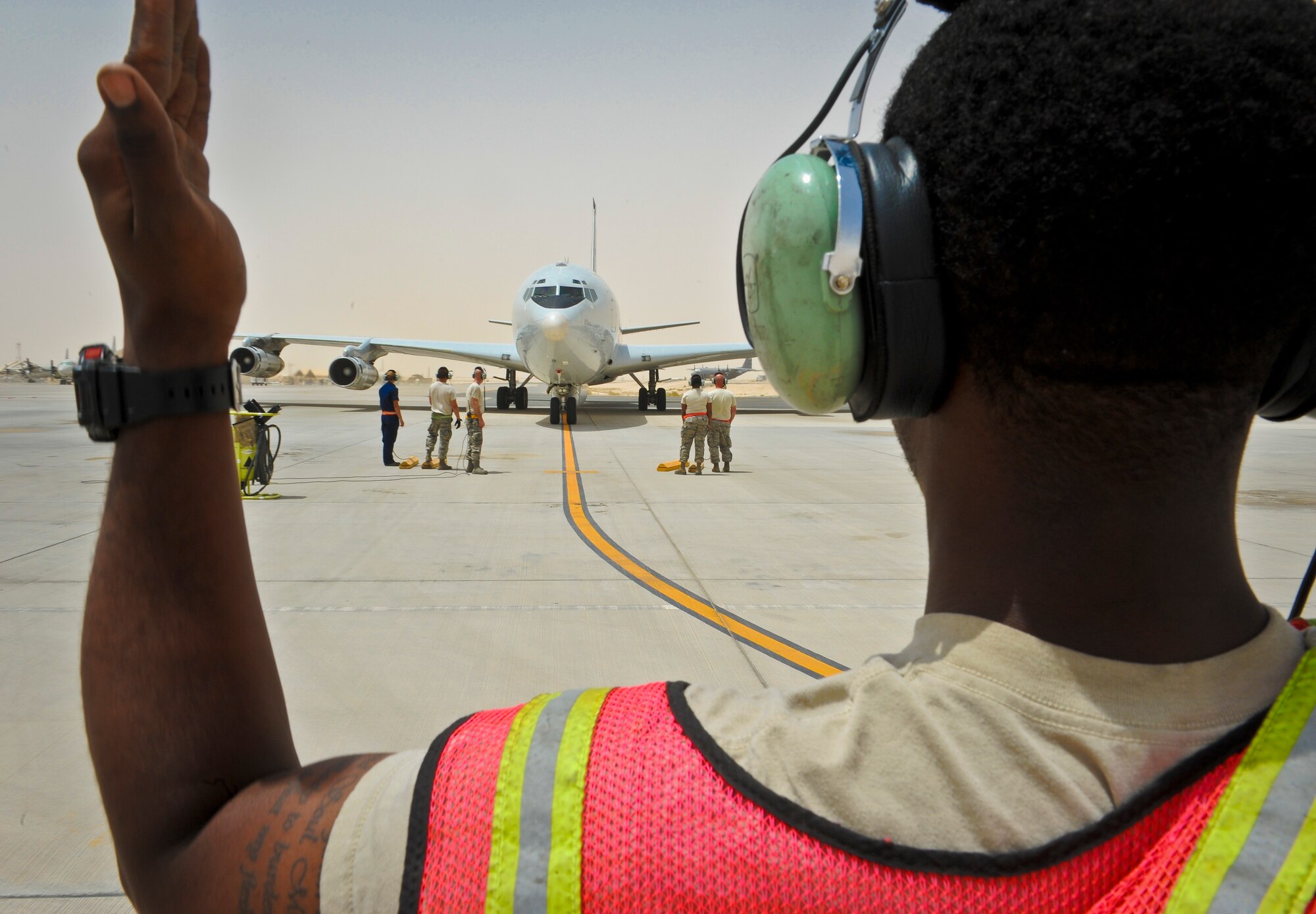 Senior Airman Jamison Johnson marshals an E-8C Joint Surveillance Target Attack Radar System as the jet returns from a mission at the 379th Air Expeditionary Wing in Southwest Asia, June 28, 2013. Joint STARS were first deployed in Operation DESERT STORM in 1991, and have since been deployed in support of various operations around the globe including ongoing operations in Afghanistan. Johnson is a 7th Expeditionary Aircraft Maintenance Unit crew chief deployed from Robins Air Force Base, Ga. (U.S. Air Force photo/Senior Airman Benjamin Stratton)