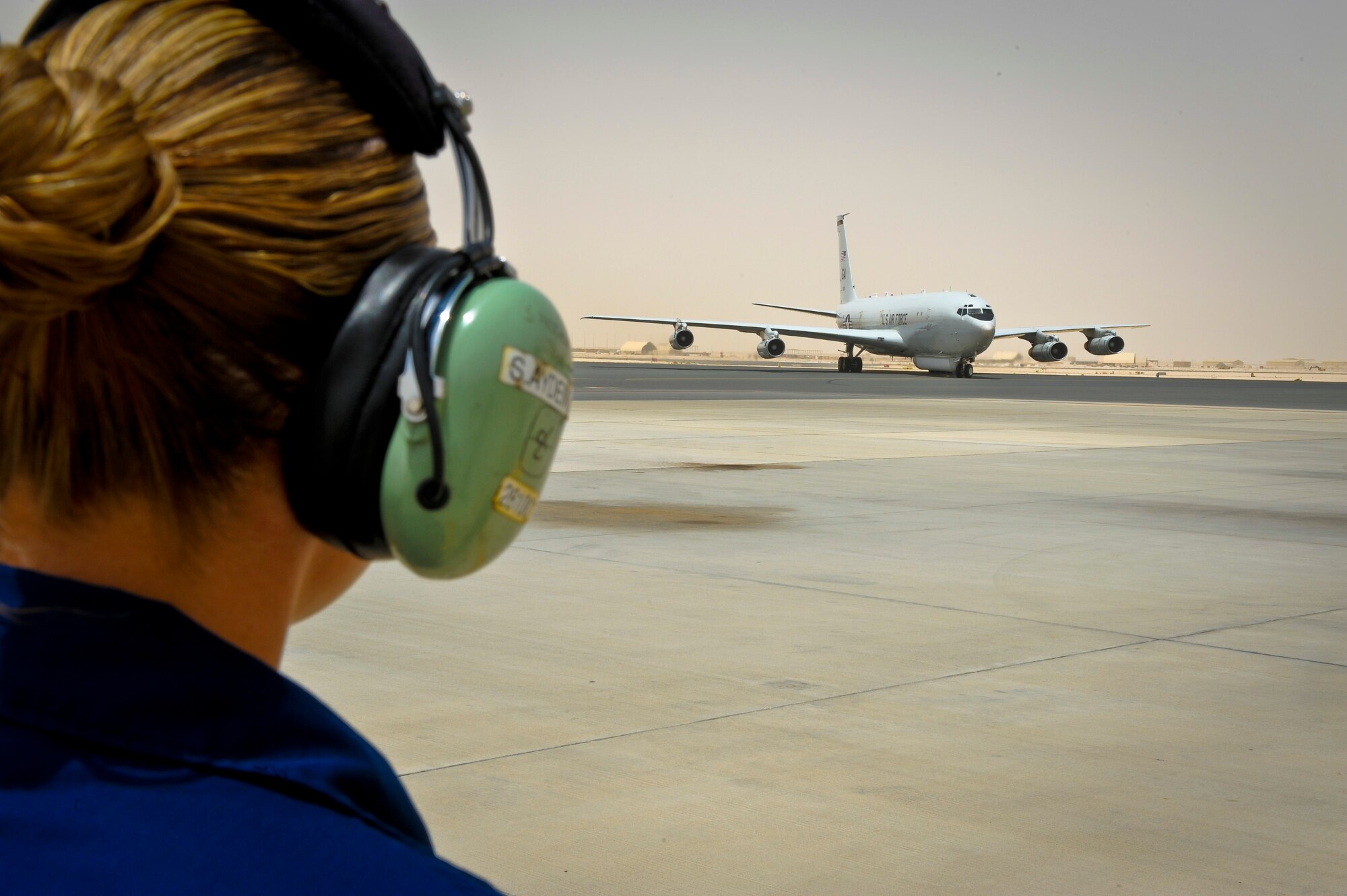Staff Sgt. Seren Aydemir prepares to ?catch? an E-8C Joint Surveillance Target Attack Radar System as it returns from a mission at the 379th Air Expeditionary Wing in Southwest Asia, June 28, 2013. Joint STARS is capable of determining the direction, speed and patterns of military activity of ground vehicles and helicopters. Aydemir is a 7th Expeditionary Aircraft Maintenance Unit instruments and flight control journeyman deployed from Robins Air Force Base, Ga. (U.S. Air Force photo/Senior Airman Benjamin Stratton)