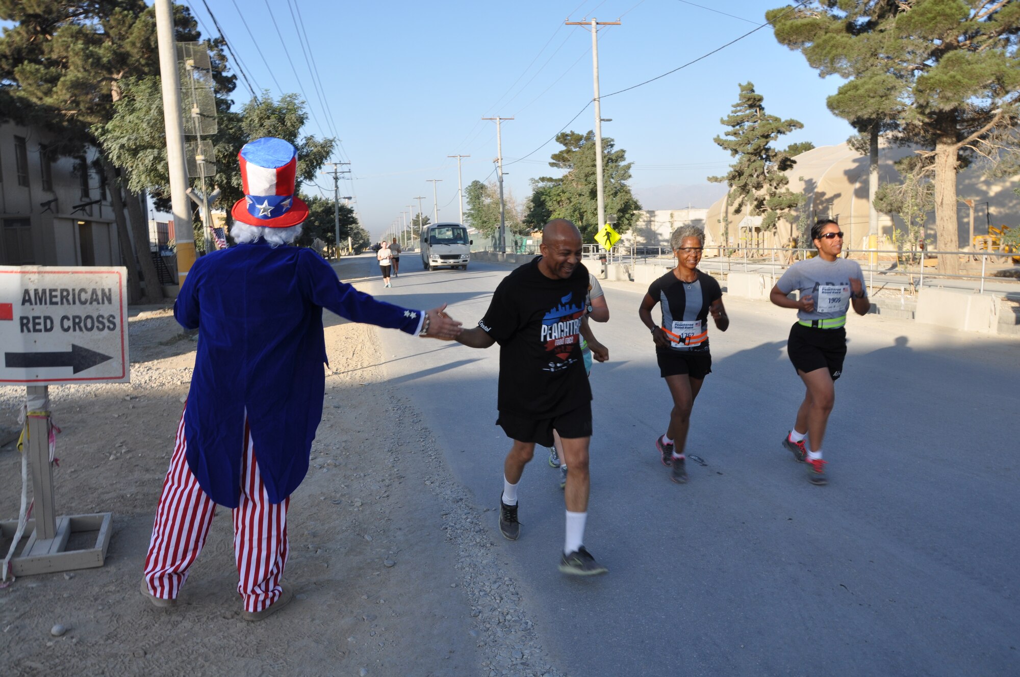Several runners maintain a good pace during an overseas shadow for the Peachtree 10-kilometer run on Bagram Airfield, Afghanistan, July 4. The morale, welfare and recreation office coordinated with the Atlanta Track Club to hold the road race, which drew more than 600 runners. (U.S. Air Force photo/Tech. Sgt. Rob Hazelett)