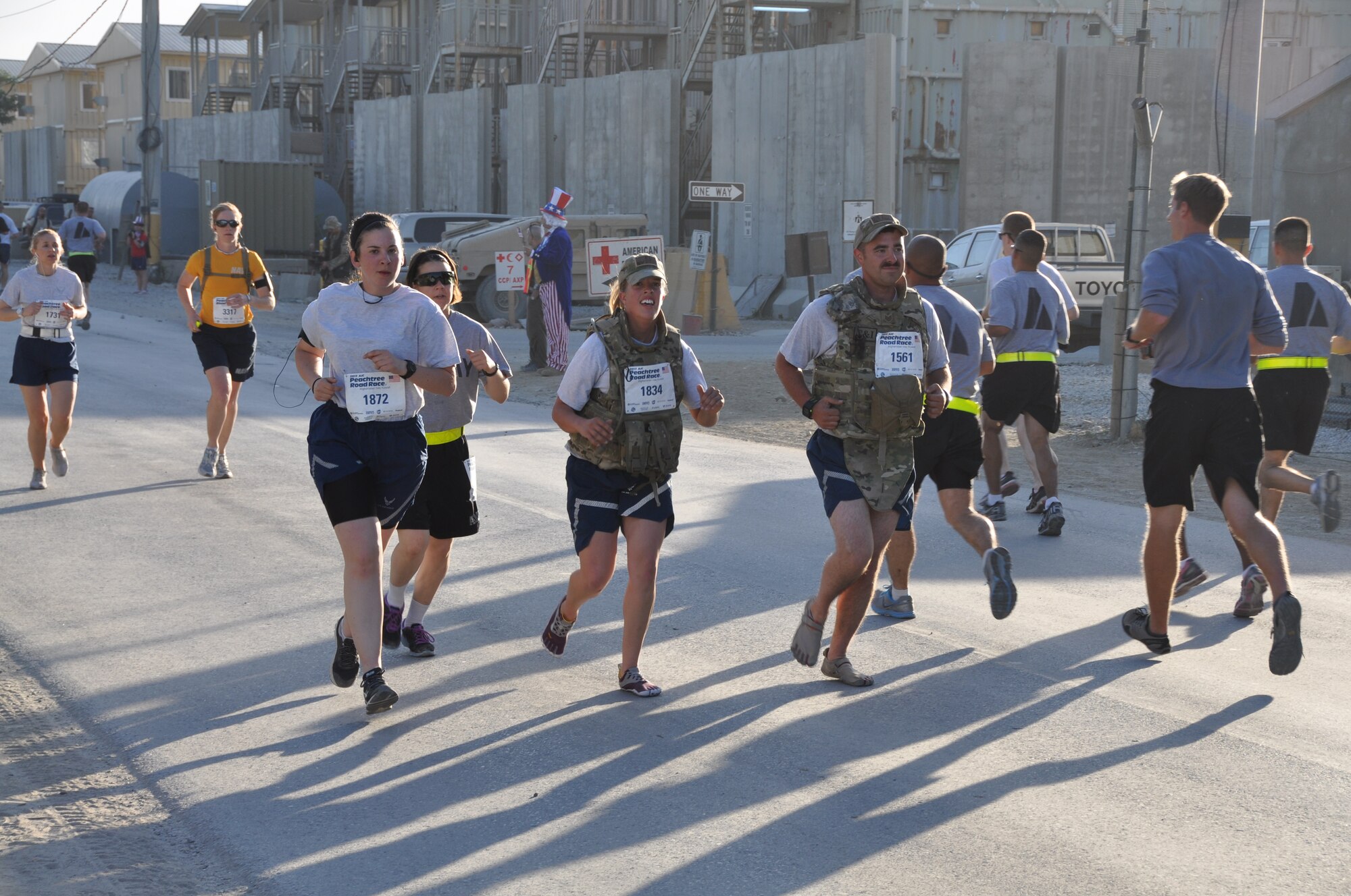 Several runners maintain a good pace during an overseas shadow for the Peachtree 10-kilometer run on Bagram Airfield, Afghanistan, July 4. The morale, welfare and recreation office coordinated with the Atlanta Track Club to hold the road race, which drew more than 600 runners. (U.S. Air Force photo/Tech. Sgt. Rob Hazelett)