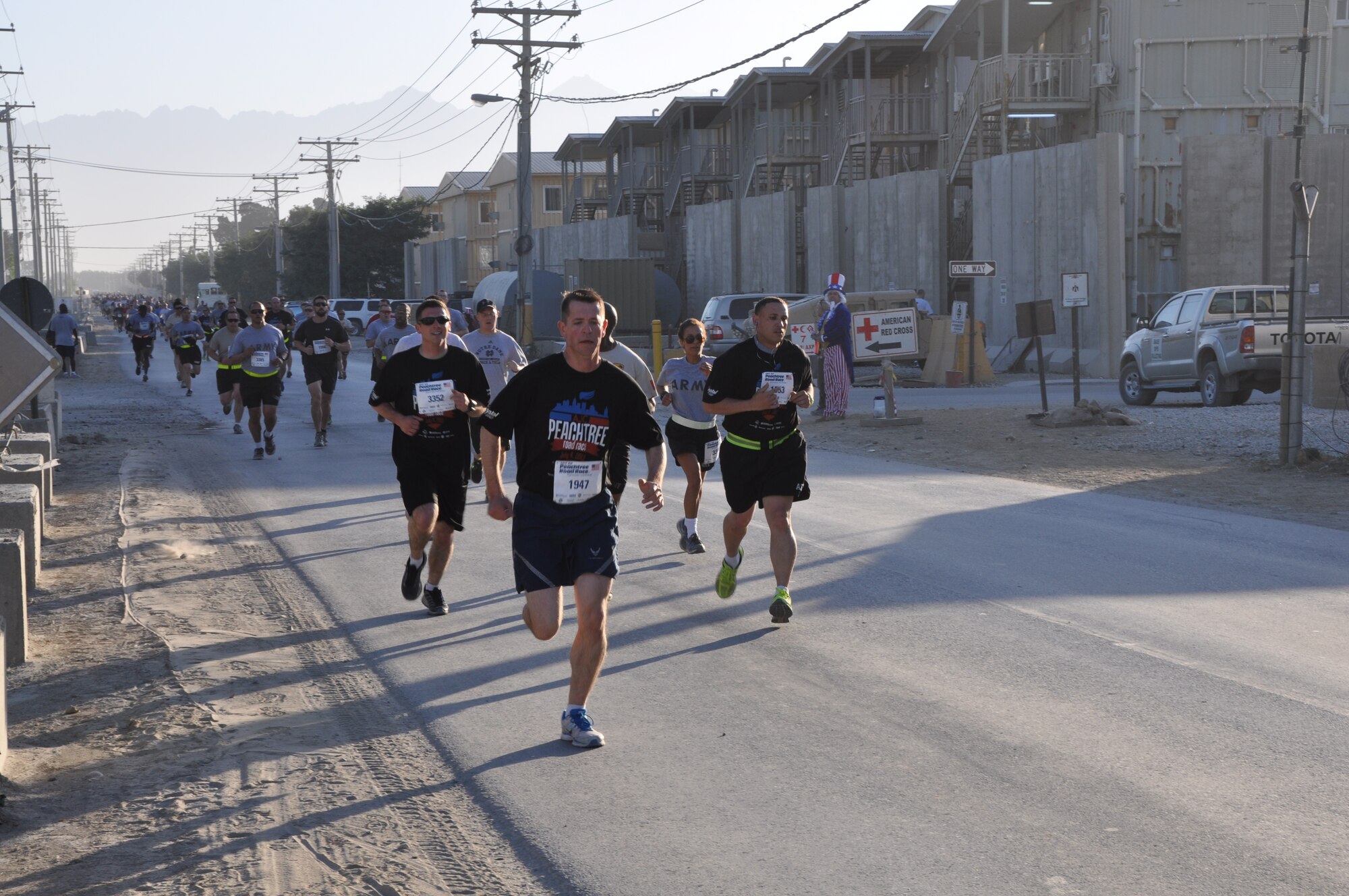Several runners maintain a good pace during an overseas shadow for the Peachtree 10-kilometer run on Bagram Airfield, Afghanistan, July 4. The morale, welfare and recreation office coordinated with the Atlanta Track Club to hold the road race, which drew more than 600 runners. (U.S. Air Force photo/Tech. Sgt. Rob Hazelett)
