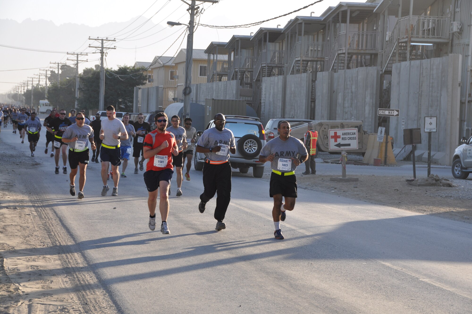 Several runners maintain a good pace during an overseas shadow for the Peachtree 10-kilometer run on Bagram Airfield, Afghanistan, July 4. The morale, welfare and recreation office coordinated with the Atlanta Track Club to hold the road race, which drew more than 600 runners. (U.S. Air Force photo/Tech. Sgt. Rob Hazelett)