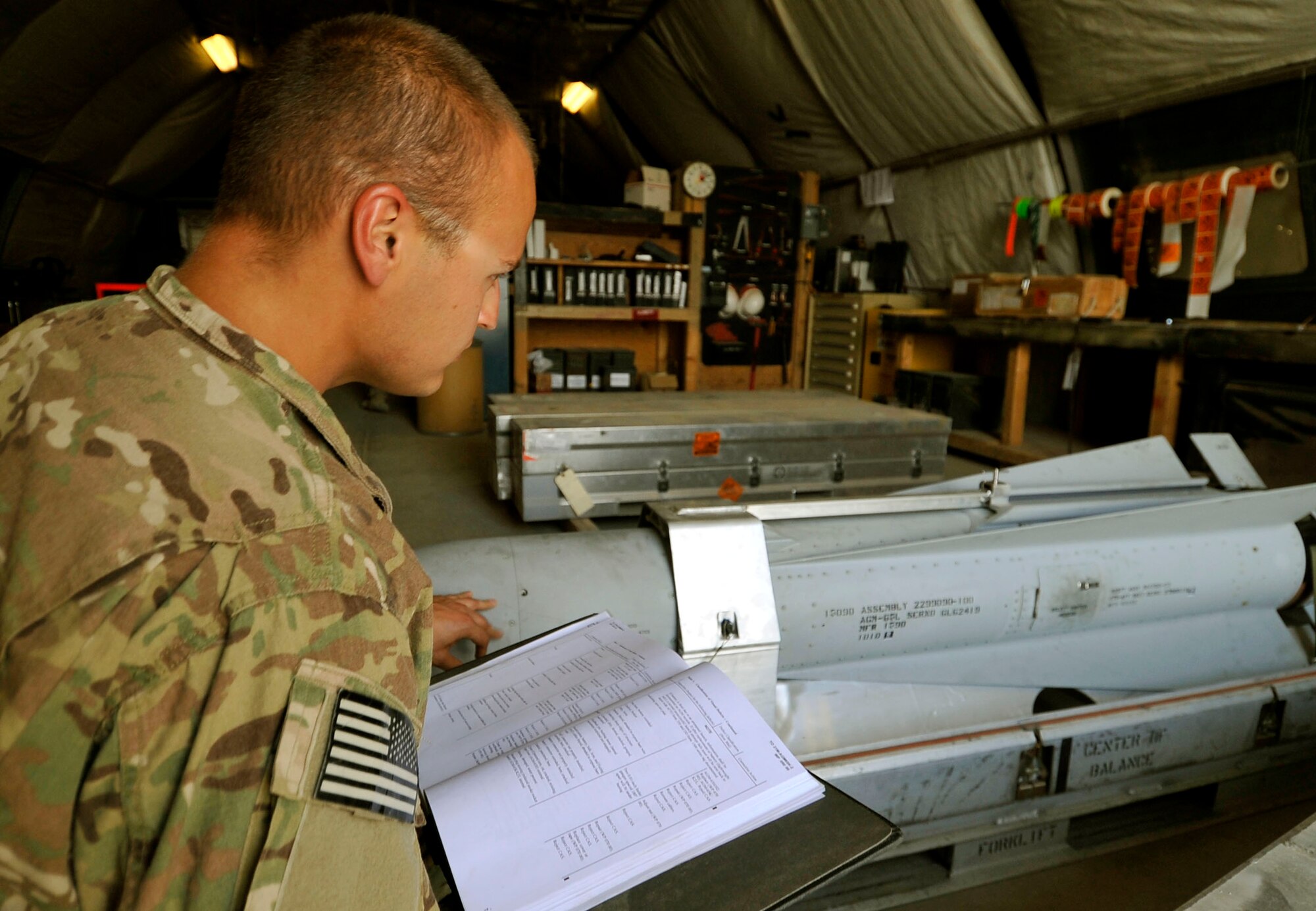 Staff Sgt. Joshua Snyder, 455th Expeditionary Munitions Flight munitions inspector, uses a technical orders to complete a munitions inspection Bagram Airfield, Afghanistan, June 13, 2013. Before use or assembly all ammo’s assets must undergo a trip through an inspection table under the eyes of the well trained inspectors. Snyder is deployed from Moody Air Force Base, Ga. and is a native of Howell, Mich. (U.S. Air Force photo/ Airman 1st Class Lance Caro)