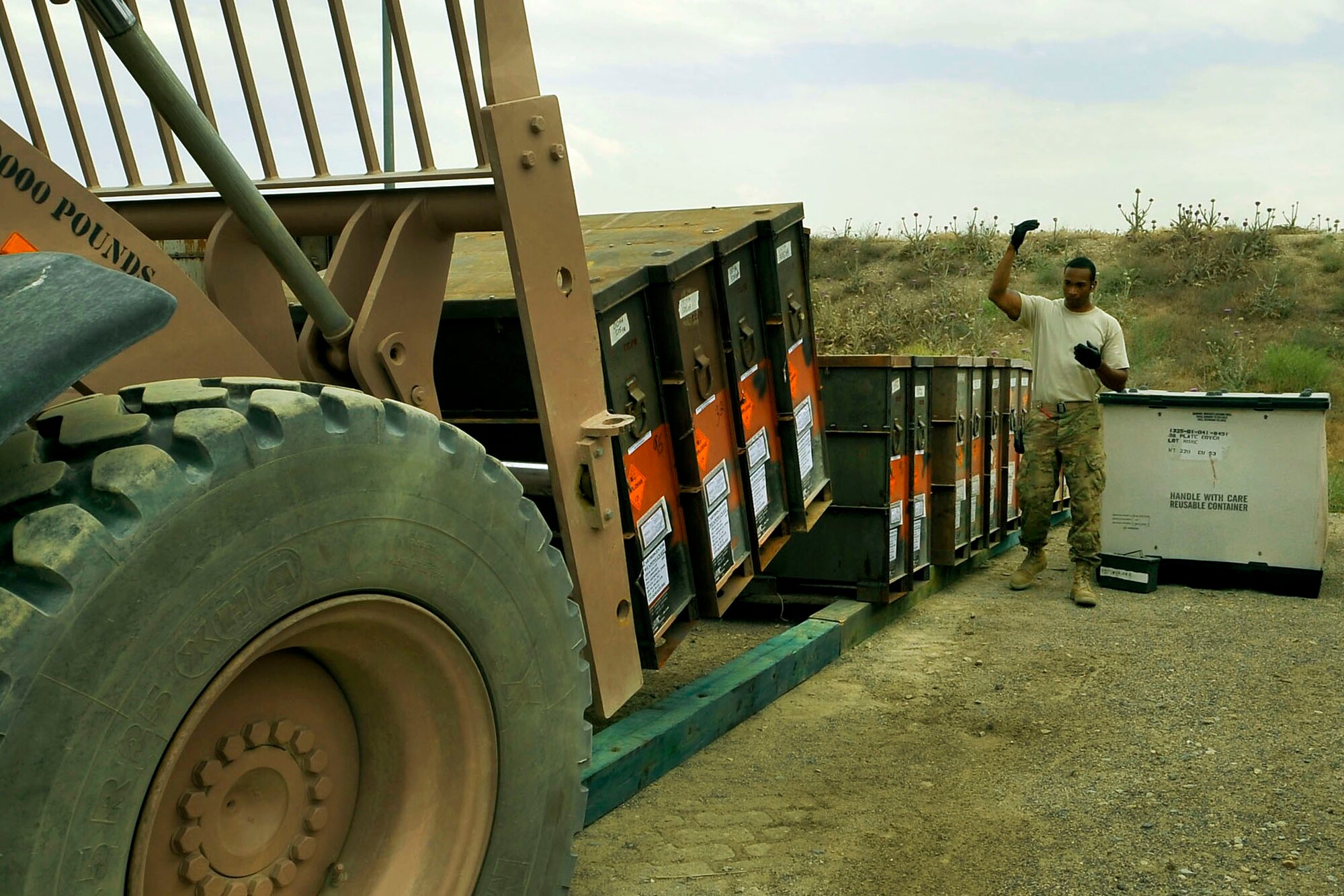 Staff Sgt. Dominique Freeman, 455th Expeditionary Maintenance Squadron precision-guided munitions crew chief, guides a forklift carrying ammo into the storage yard at Bagram Airfield, Afghanistan, June 13, 2013. The 455th EMXS ammo flight is responsible for providing munitions and countermeasures, such as chaff and flare, to U.S. Air Force units as well as providing storage facilities for the other military branches here. Freeman is deployed from Moody Air Force Base, Ga. and is a native of Jacksonville, Fla. (U.S. Air Force photo/ Airman 1st Class Lance Caro )