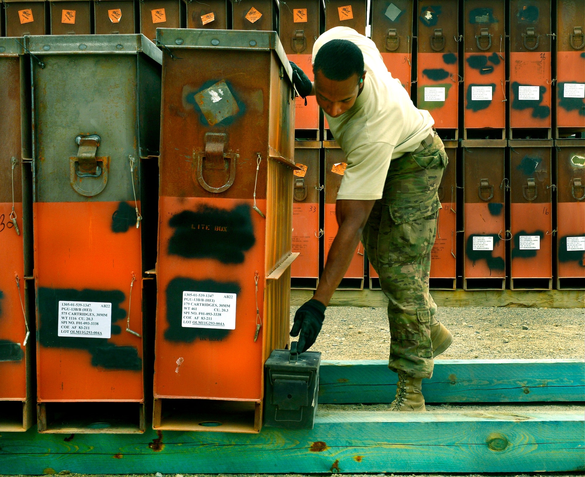 Staff Sgt. Dominique Freeman, 455th Expeditionary Maintenance Squadron precision-guided munitions crew chief, places an empty ammo box as a marker in the ammo storage yard at Bagram Airfield, Afghanistan, June 13, 2013. The 455th EMXS ammo flight is responsible for providing munitions and countermeasures, such as chaff and flare, to U.S. Air Force units as well as providing storage facilities for the other military branches here. Freeman is deployed from Moody Air Force Base, Ga. and is a native of Jacksonville, Fla. (U.S. Air Force photo/ Staff Sgt. Stephenie Wade)