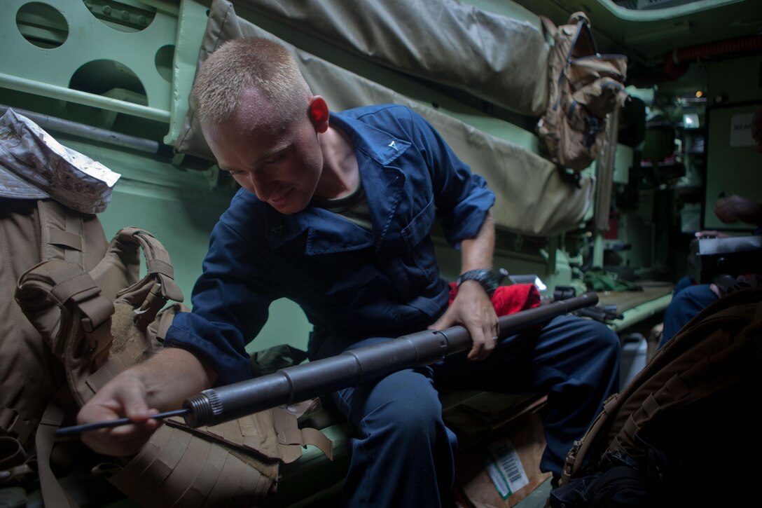Lance Cpl. Sean J. McSweeney, an amphibious assault vehicle crewman with Company G., Battalion Landing Team 2nd Battalion, 4th Marines, 31st Marine Expeditionary Unit, and native of Palmyra, N.J., cleans the barrel of a .50 caliber machine gun inside an AAV here, June 29. The Marines and Sailors of the 31st MEU are constantly engaged in training, education and gear maintenance while embarked aboard the ship, taking advantage of their time at sea. The 31st MEU is the only continuously forward-deployed MEU and is the Marine Corps’ force in readiness in the Asia-Pacific region.