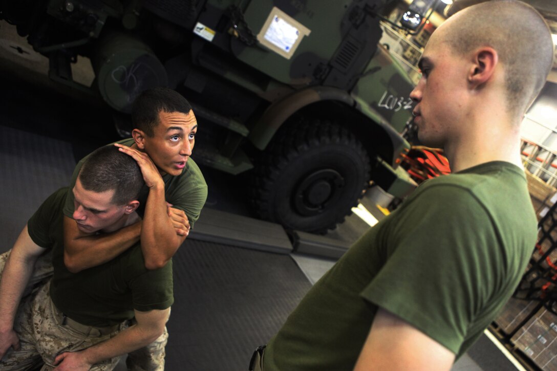 Corporal Alan B. Rubio, a heavy equipment mechanic with  Combat Logistics Battalion 31, 31st Marine Expeditionary Unit, and native of Bakersfield, Calif., demonstrates a figure-four blood choke during a Marine Corps Martial Arts Program class here, July 1. While embarked with the ships of Amphibious Squadron 11, the Marines and Sailors of the 31st MEU utilize their time underway to maintain and advance their training. The 31st MEU is the only continuously forward-deployed MEU and is the Marine Corps’ force in readiness in the Asia-Pacific region.