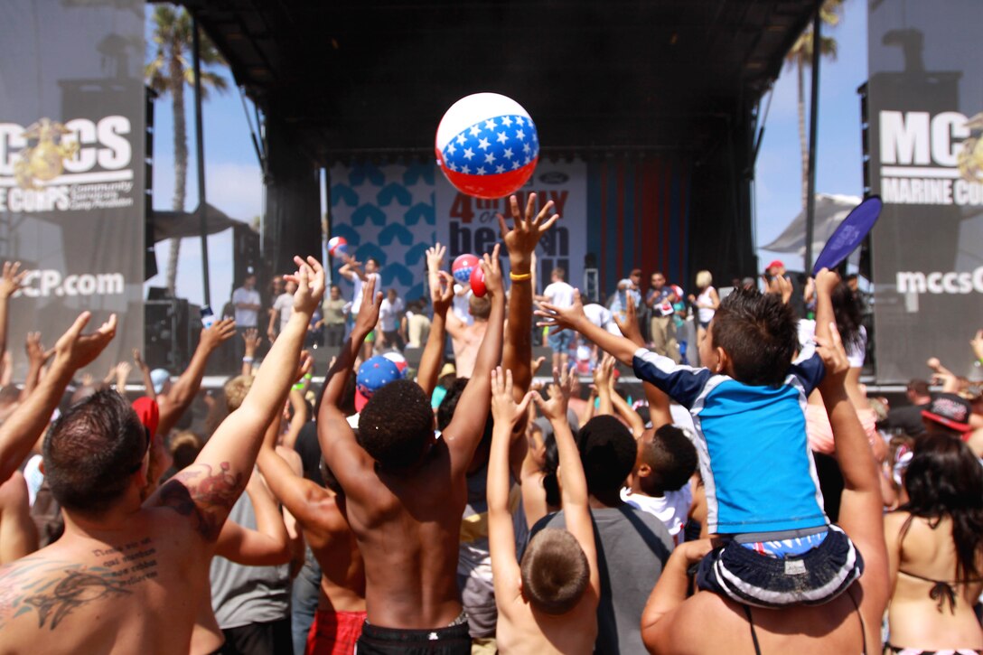 Beach goers jump and reach to volley a beach ball at Del Mar Beach here during the Fourth of July Beach Bash. The daylong event featured live entertainment, free give-aways, a military tribute video and concluded with fireworks.
