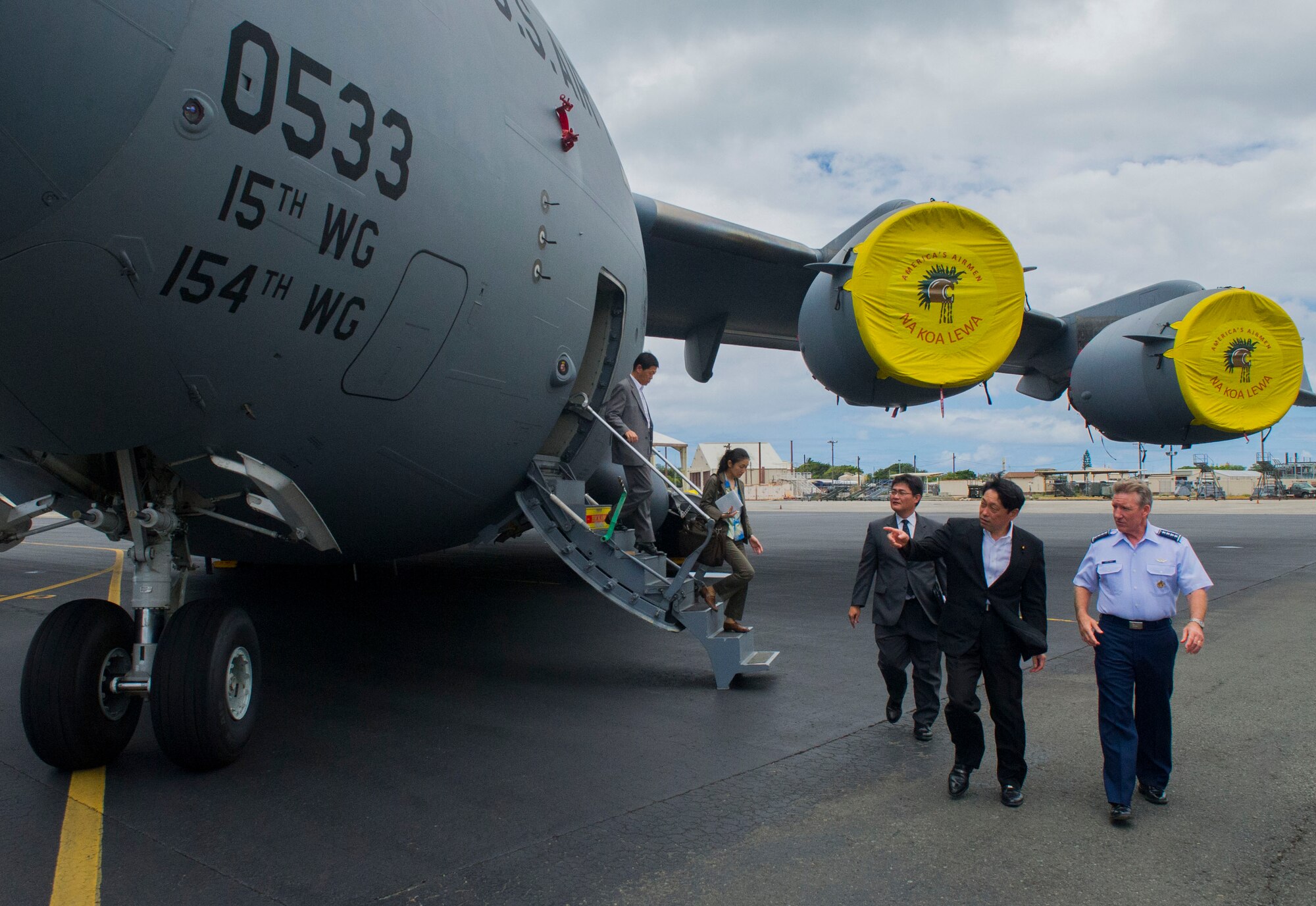 His Excellency Itsunori Onodera, Minister of Defense of Japan, walks with General Hawk Carlisle, Pacific Air Forces commander, during a tour of Joint Base Pearl Harbor-Hickam, Hawaii, flightline July 2. One of the highlights of the tour was visiting the C-17 Globemaster III, which plays a key role in PACAF's global reach capability throughout the Asia-Pacific region. (U.S. Air Force photo by Staff Sgt. Nathan Allen)