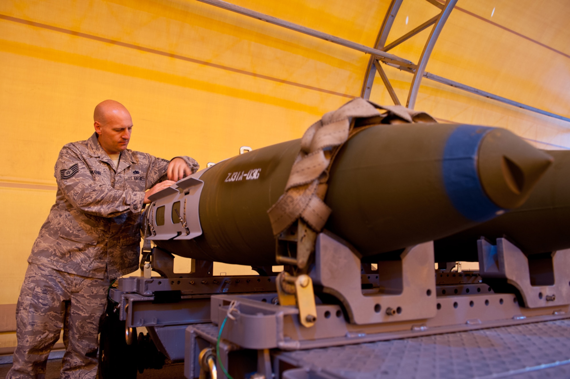 JOINT BASE ELMENDORF-RICHARDSON, Alaska - - Tech. Sgt. William Mann, assigned to the 3rd Munitions Squadron, assistant noncommissioned officer in charge in Production Flight, inspects the analog connection that a computer is linked to in order to test the Global Positioning Unit and tail fins on the Guided Bomb Unit-32, June 7, 2013.   (U.S. Air Force photo/Johnathon Green)