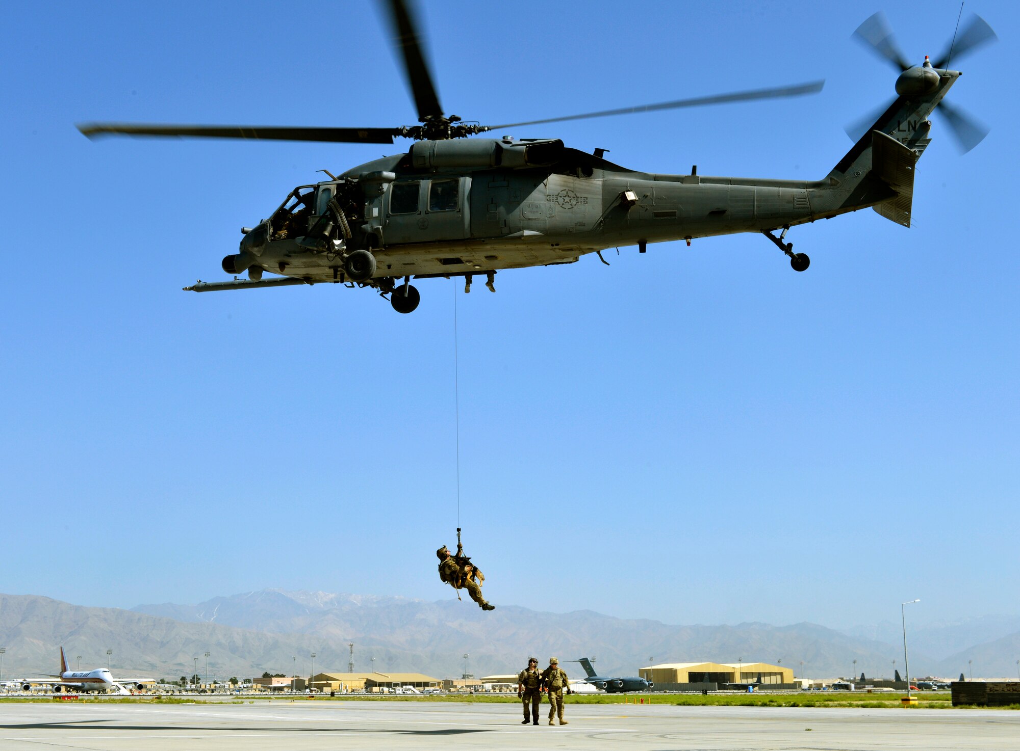 Airman 1st Class Jason Fischman, 83rd Expeditionary Rescue Squadron pararescueman, hoists an U.S. Army tactical explosive detection dogs into a HH-60G Pave Hawk helicopter during a joint rescue training scenario at Bagram Airfield, Afghanistan, June 21, 2013.  This training was a first for both branches and prepared them for future rescue missions.  Fischman is deployed from Royal Air Force Lakenheath, England. (U.S. Air Force photo/ Staff Sgt. Stephenie Wade)