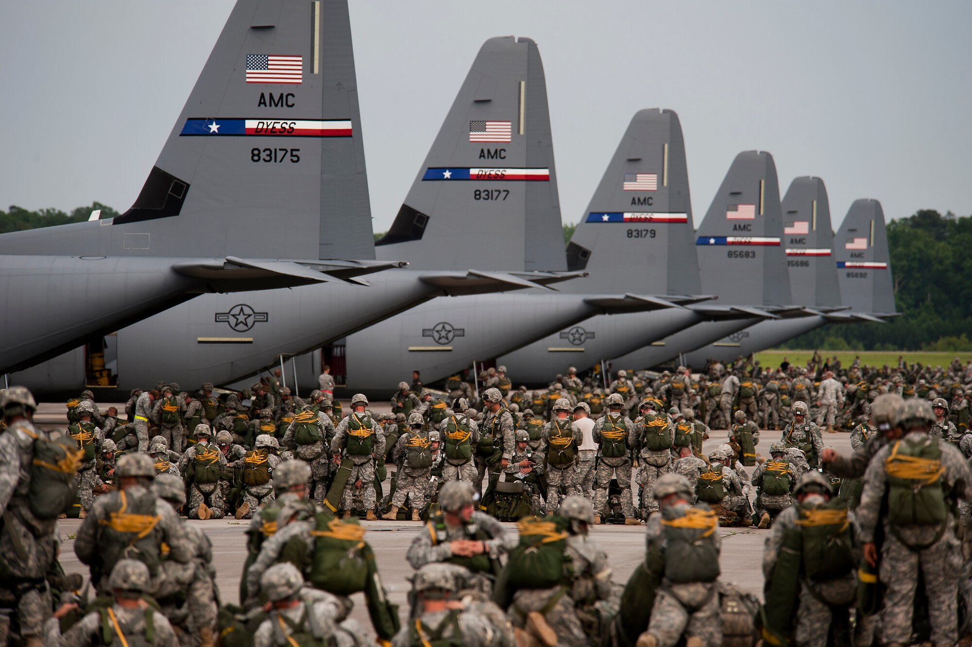 Soldiers from the 82nd Airborne Division ready their gear prior to jumping from Air Force C-130J Hercules during a Joint Operation Access exercise June 24, 2013, at Pope Field, N.C.. A total of 2,426 paratroopers jumped out of C-130Js assigned to Dyess, Air Force Base, Texas, during the 12-day exercise. JOAX is a combined military training exercise designed to prepare Airmen and Soldiers to respond to worldwide crises and contingencies. (U.S. Air Force photo/Airman 1st Class Damon Kasberg)