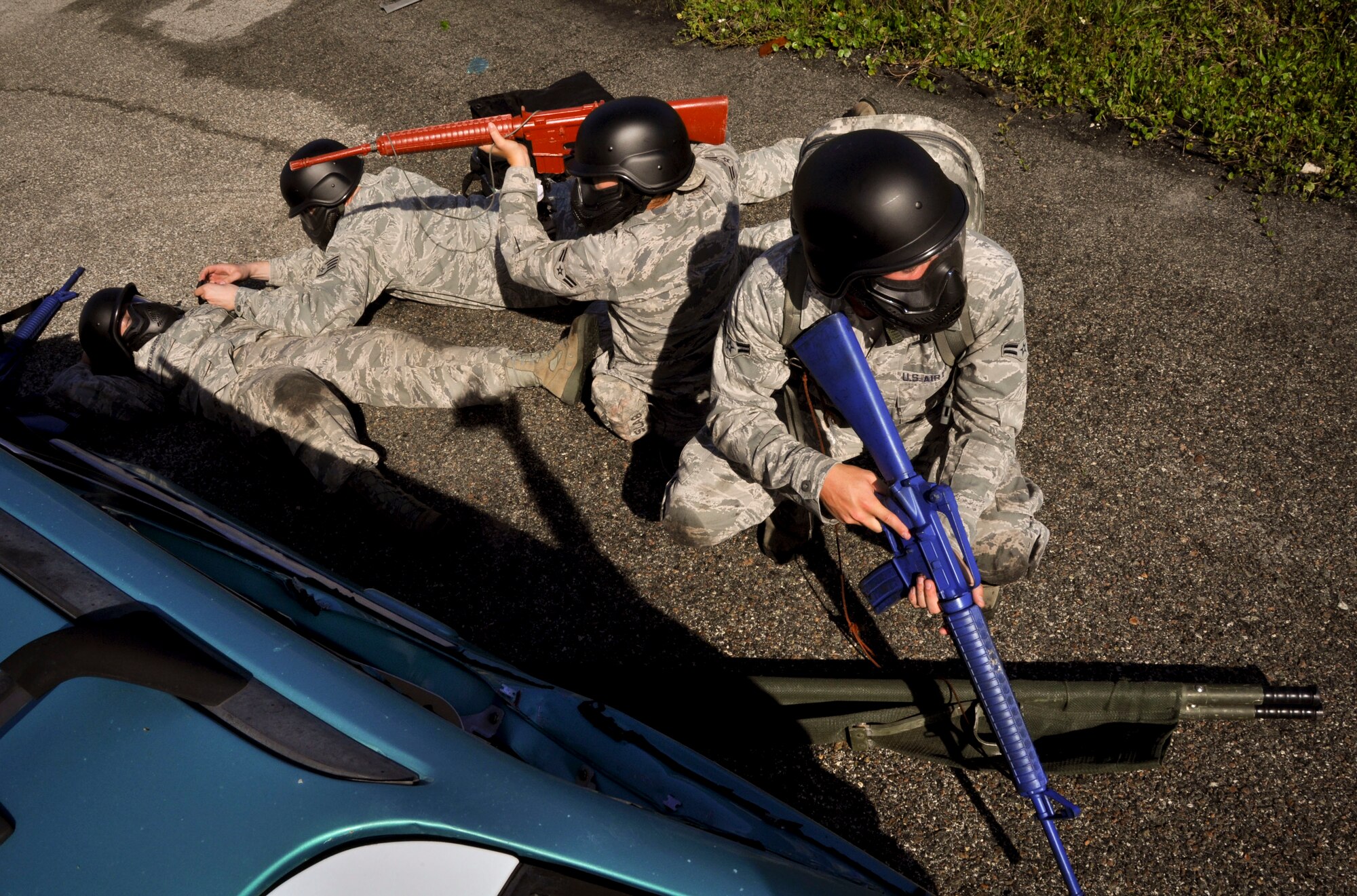 MACDILL AIR FORCE BASE, Fla. – Emergency medical response Airmen in the active duty and reserve Air Force and Air National Guard post security while they administer emergency care to a teammate simulating a combat wound. The Airmen gathered here to participate in the three-day Tactical Combat Casualty Care Course in order to match their emergency medical care job fields with tactical training allowing them to complete their mission in combat environments. (U.S. Air Force photo by Tech. Sgt. Shawn Rhodes)