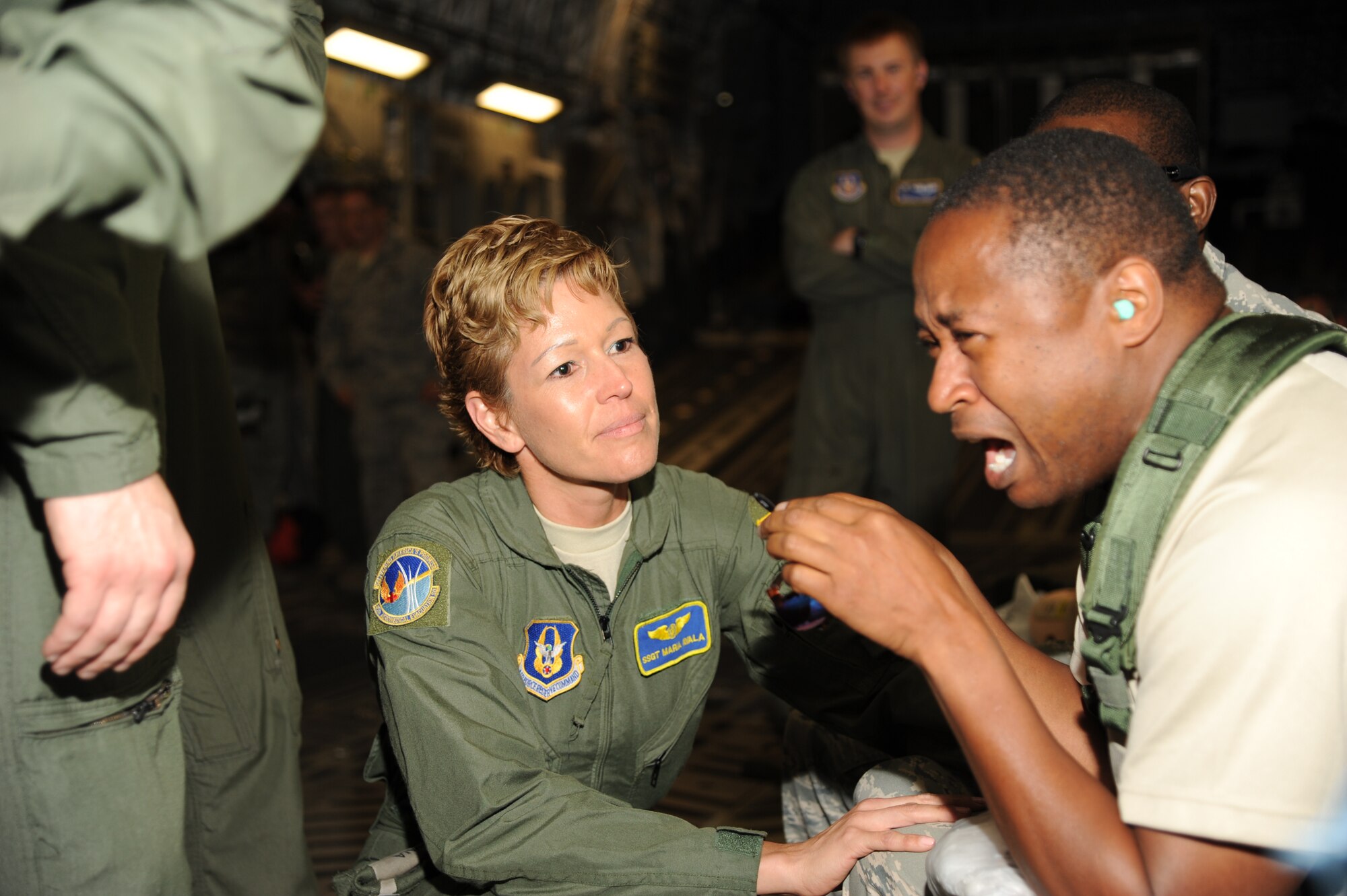 MACDILL AIR FORCE BASE, Fla. -- Technical Sgt. Maria Ayala, 45th Aeromedical Evacuation Squadron, comforts a distraught patient, Maj. Alvin Bradford, 927th Aeromedical Staging Squadron, during a medical exercise June 3, 2013, at MacDill Air Force base, Fla. The exercise was designed to help members of the Air Force Reserve units to enhance the skills necessary for caring for patients during a medical evacuation. (Official U.S. Air Force photo by Staff Sgt. Jennie Chamberlin)  