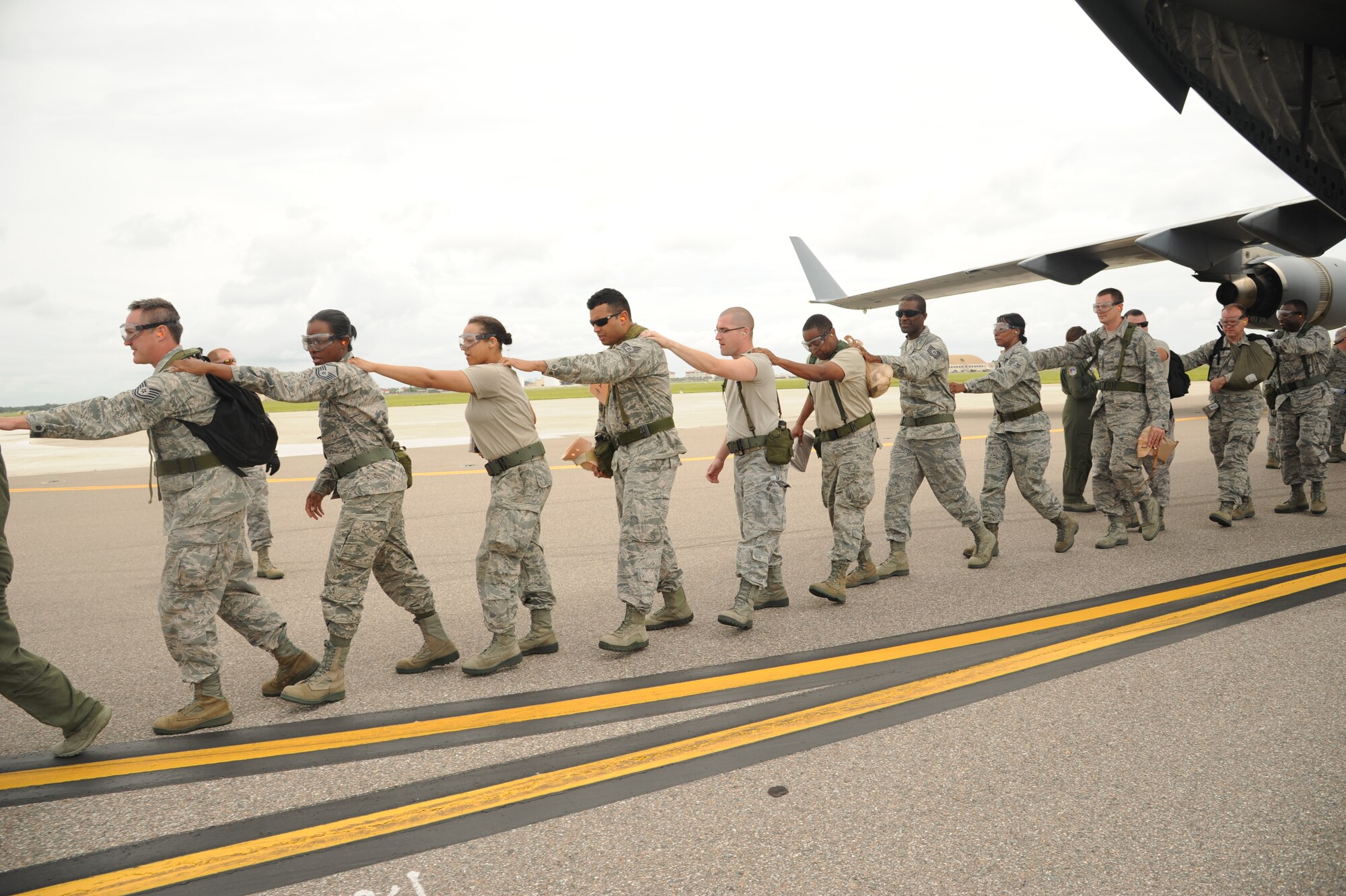 MACDILL AIR FORCE BASE, Fla. -- Reservists from the 927th Aeromedical Staging Squadron, acting as injured patients, fall in line while off-loading from a C-17 Globemaster III during a medical exercise June 3, 2013 at MacDill Air Force Base, Fla. The 927th ASTS participated in a training exercise that prepares its members for the quick and efficient transfer of patients from their in-flight caretakers to a ground medical crew. (Official U.S. Air Force photo/Staff Sgt. Jennie Chamberlin) 