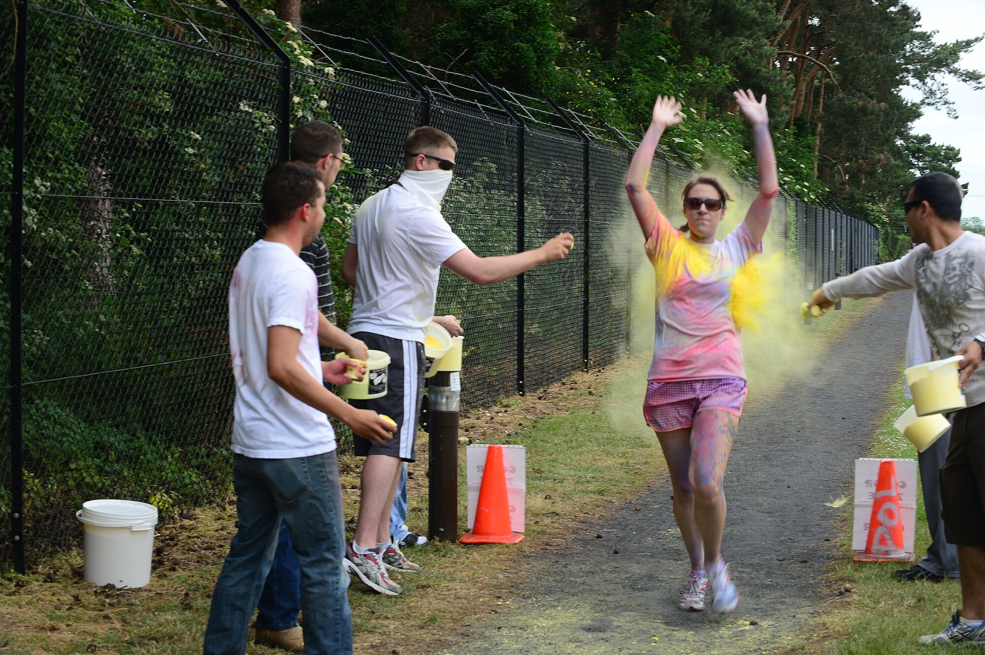 ROYAL AIR FORCE LAKENHEATH, England – Senior Airman Samantha Hamilton, 48th Medical Surgical Squadron medical technician, finishes the RAF Lakenheath color run July 4, 2013. Hamilton was the first female to finish the run, which   raised money for the upcoming Air Force Ball in September.  (U.S. Air Force photo by Airman 1st Class Dana Butler)

