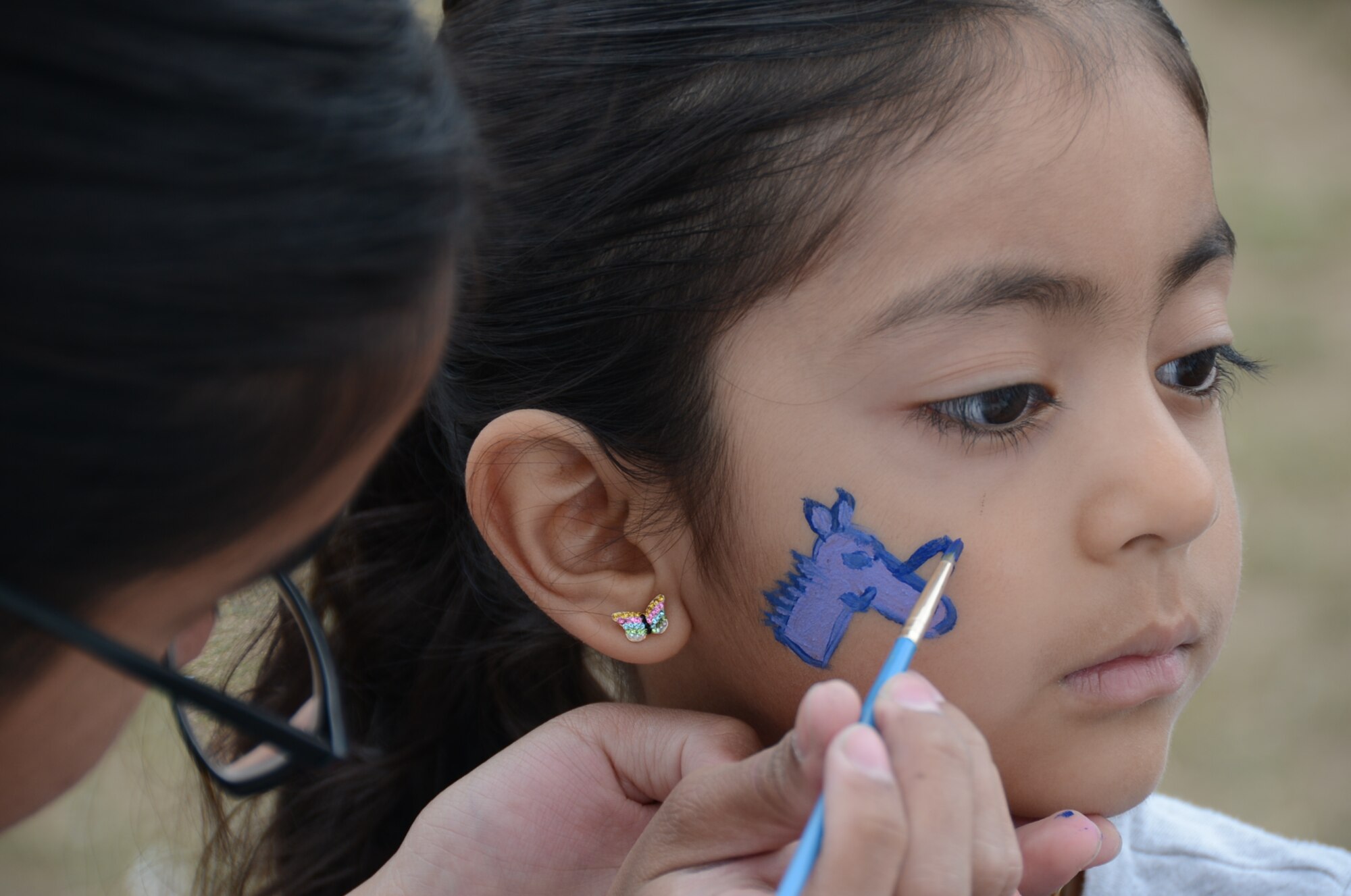 ROYAL AIR FORCE LAKENHEATH, England – Reyna Lopez, 6-year-old daughter of Staff Sgt. Rogelio Lopez, 100th Maintenance Squadron, receives a face painting at the 48th Maintenance Group Fourth of July Fest, July 4, 2013. The 48th MXG hosted food booths, games for kids, and a softball tournament. (U.S. Air Force photo by Airman 1st Class Trevor T. McBride) 