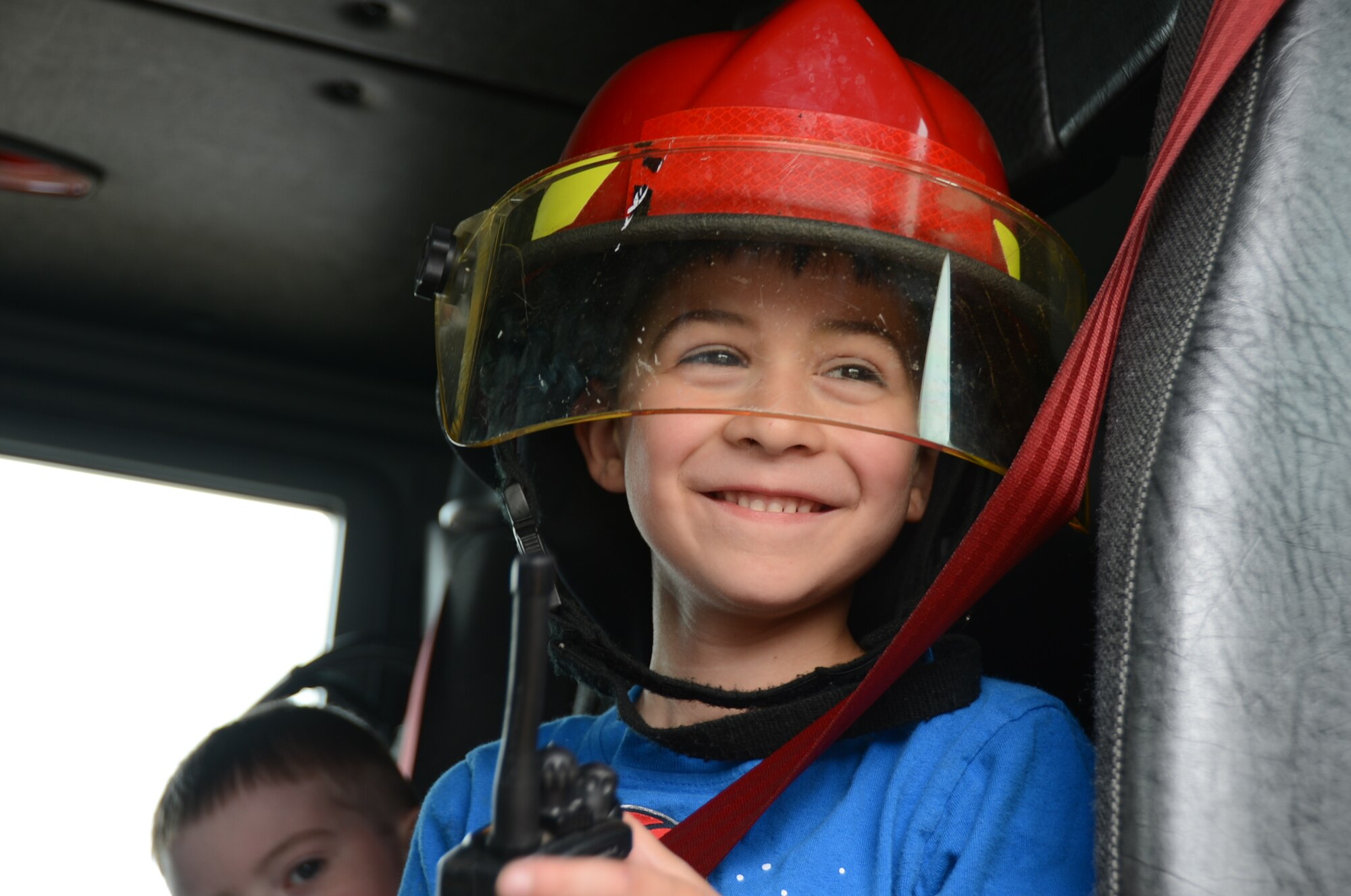 ROYAL AIR FORCE LAKENHEATH, England – Gavin McDonald, 7-year-old son of Staff Sgt. James McDonald, 48th Equipment Maintenance Squadron air ground equipment, tries on firefighting equipment at the 48th Maintenance Group Fourth of July Fest, July 4, 2013. The 48th MXG hosted food booths, games for kids, and a softball tournament. (U.S. Air Force photo by Airman 1st Class Trevor T. McBride) 