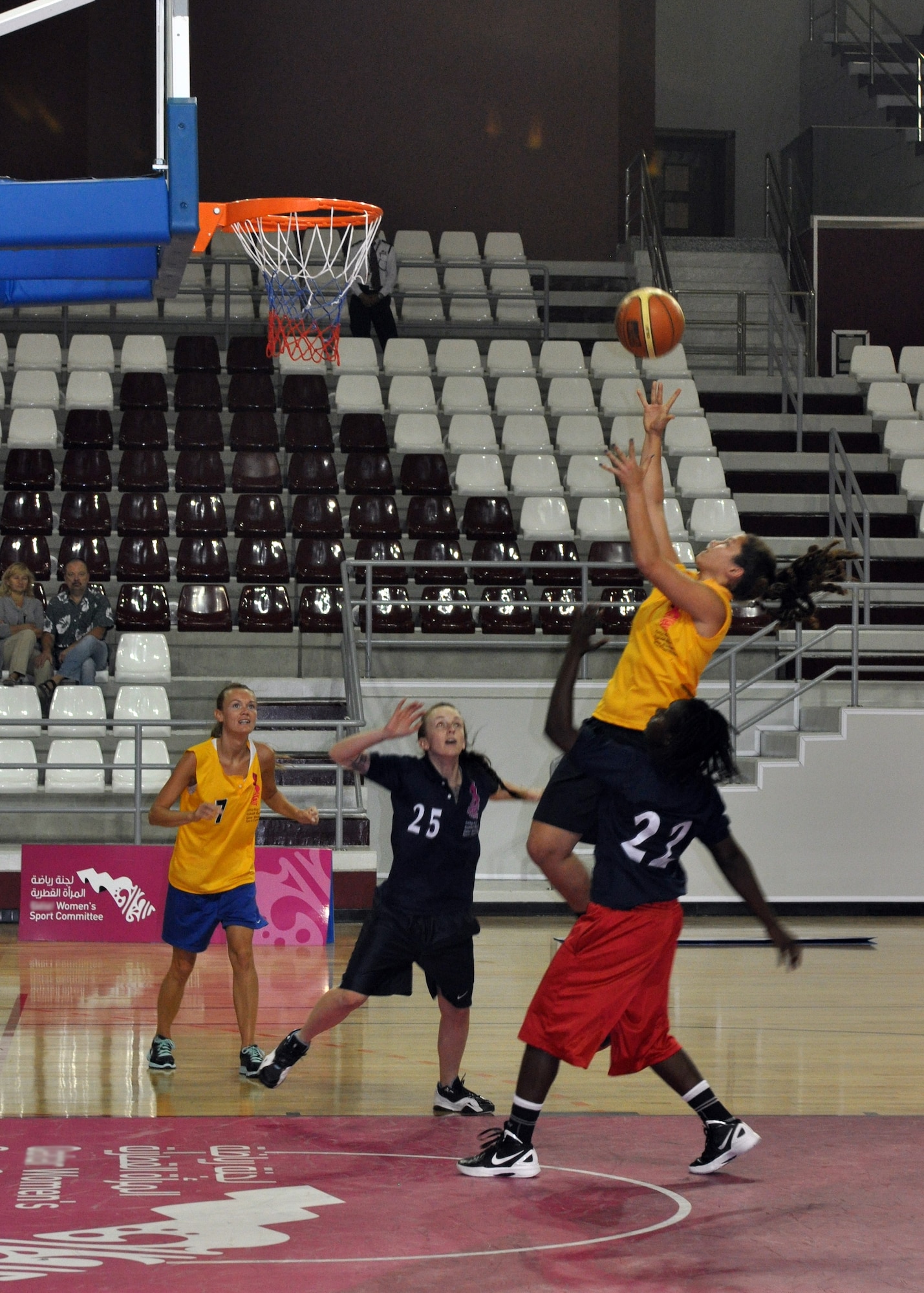 Staff Sgt. Kalyn Hoeppner and Senior Airman Tkeisha Salmon reach to defend an opponent during a local women’s basketball tournament in Southwest Asia, June 28, 2013. Eight service members from the Army camp and air base participated in the tournament, interacting with the local public and strengthening the base’s partnership with the surrounding community. Hoeppner is a 379th Aerospace Medical Operations Squadron aerospace medical technician deployed from Joint Base Langley-Eustis, Va., and Salmon is a 379th Expeditionary Security Force Squadron armorer deployed from MacDill Air Force Base, Fl. (U.S. Air Force photo/1st Lt. Susan Harrington)