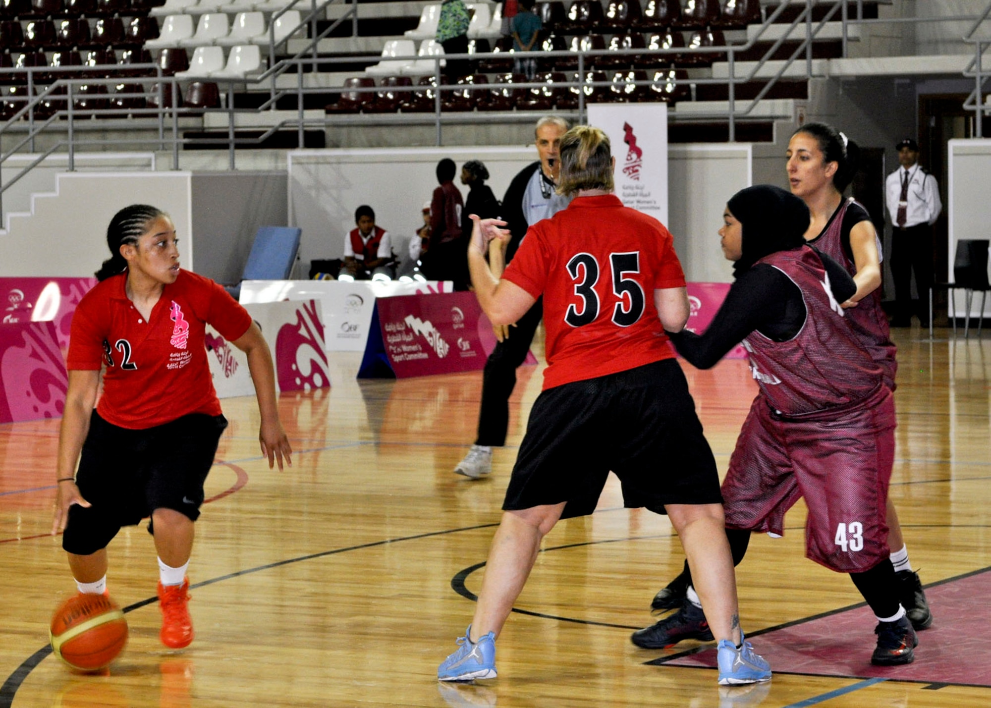 Airman 1st Class Akia Carter dribbles the ball around opponents during a local women’s basketball tournament in Southwest Asia, June 28, 2013. Eight service members from the Army camp and air base participated in the tournament, interacting with the local public and strengthening the base’s partnership with the surrounding community.  Carter is a 379th Expeditionary Logistics Readiness Squadron traffic management operator deployed from Travis Air Force Base, Calif. (U.S. Air Force photo/1st Lt. Susan Harrington)