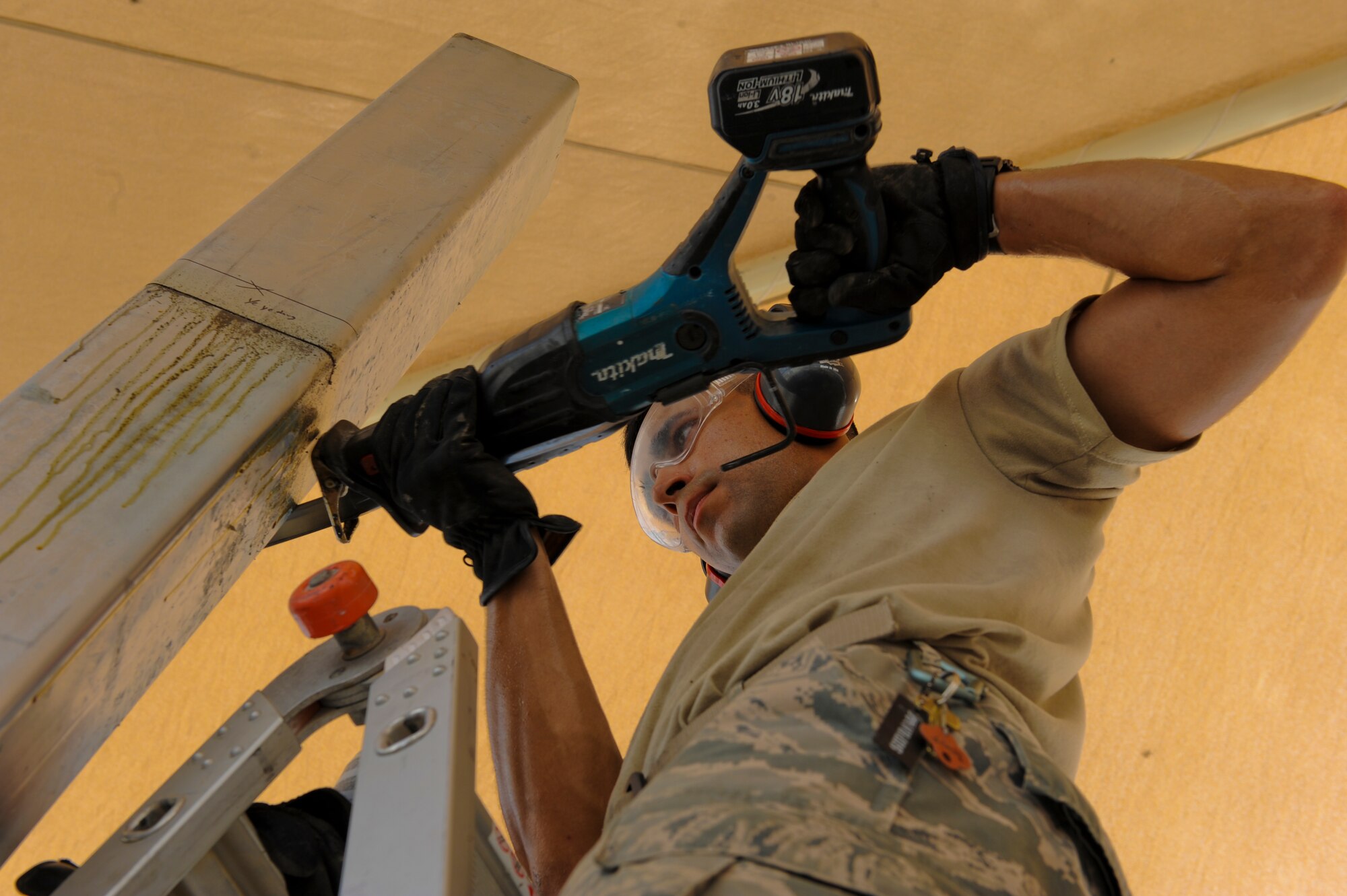 U.S. Air Force Senior Airman Andrew Gutierrez, 380th Expeditionary Civil Engineer Squadron structures apprentice, saws a pillar to the proper height needed for a wall at an undisclosed location in Southwest Asia July 2, 2013. The wall will be part of a new morale area being built for the 380th Expeditionary Force Support Squadron. Gutierrez is native to El Paso, Texas, and is deployed from Joint Base McGuire-Dix-Lakehurst, N.J. (U.S. Air Force photo by Staff Sgt. Joshua J. Garcia) 
