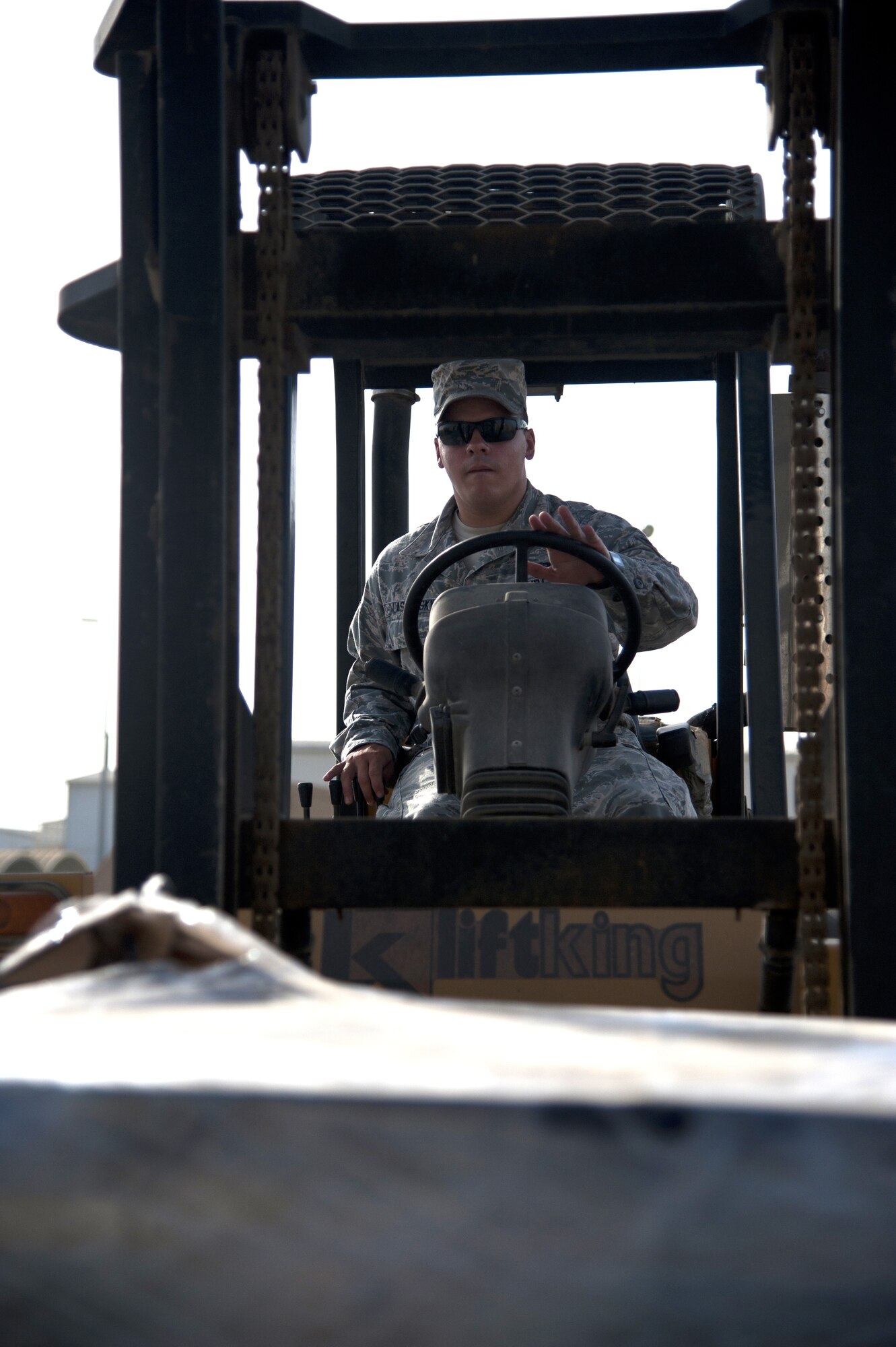 U.S. Air Force Airman 1st Class Mickey Laskowsky, 380th Expeditionary Force Support Squadron food services technician, uses a 6K forklift to deliver water to one of his drop points at an undisclosed location in Southwest Asia July 3, 2013. Laskowsky is the main forklift operator for the 380th EFSS where he uses it to deliver water to 58 different stops a day. He is originally from Pittsburgh, Penn., and is stationed with the 171st Air Refueling Wing with the Pennsylvania Air National Guard. (U.S. Air Force photo by Senior Airman Jacob Morgan)