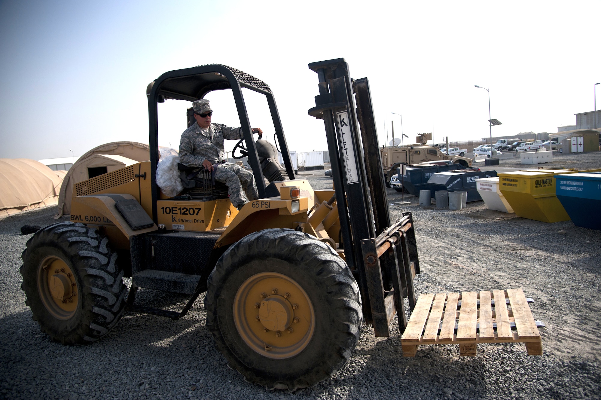 U.S. Air Force Airman 1st Class Mickey Laskowsky, 380th Expeditionary Force Support Squadron food services technician, drives his all-terrain 6K forklift to get more pallets of water for delivery at an undisclosed location in Southwest Asia July 3, 2013. Laskowsky is the main forklift operator for the 380th EFSS where he uses it to deliver water to 58 different stops a day. He is originally from Pittsburgh, Penn., and is stationed with the 171st Air Refueling Wing with the Pennsylvania Air National Guard. (U.S. Air Force photo by Senior Airman Jacob Morgan)