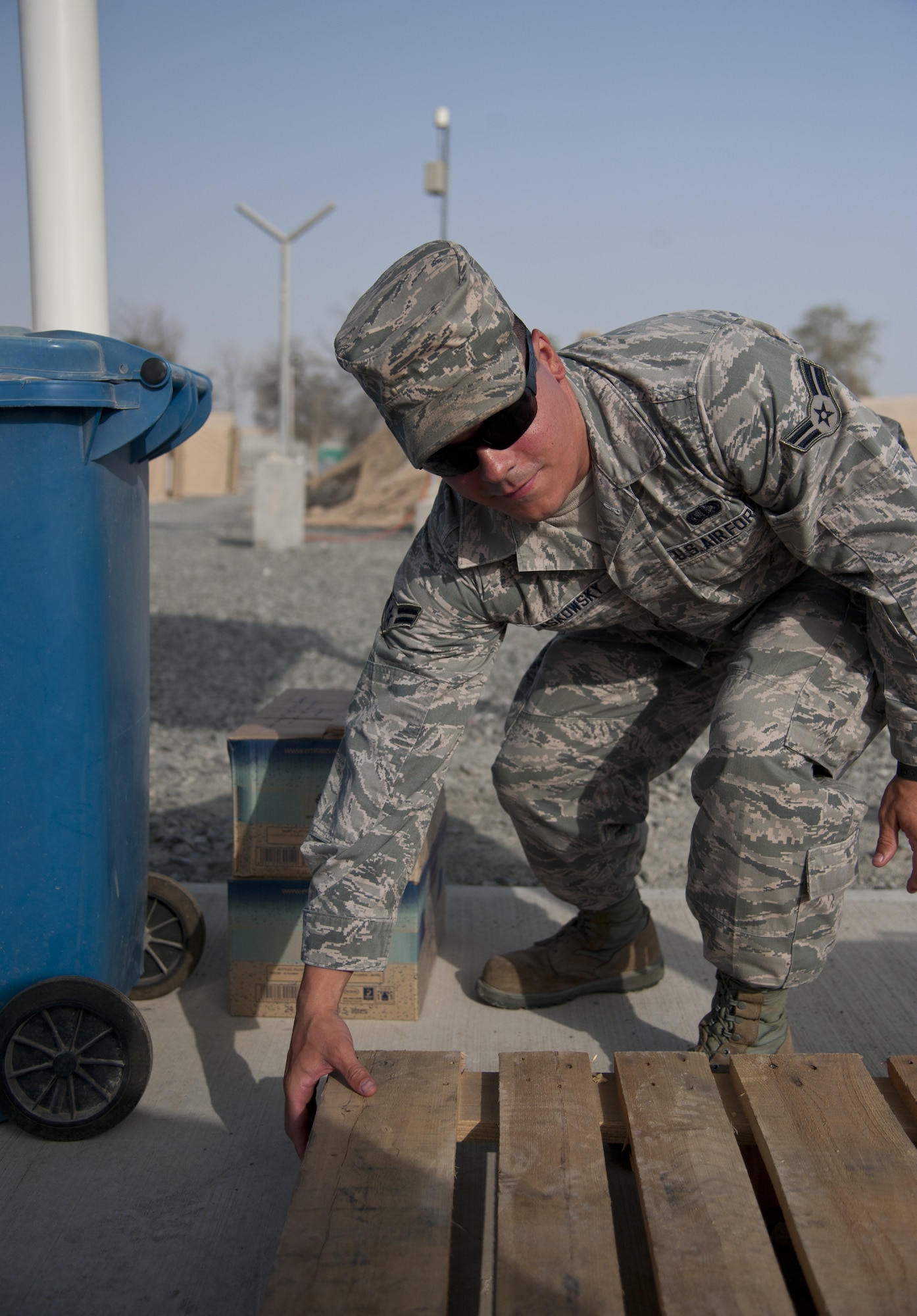 U.S. Air Force Airman 1st Class Mickey Laskowsky, 380th Expeditionary Force Support Squadron food services technician,  picks up an empty pallet at one of his drop points at an undisclosed location in Southwest Asia July 3, 2013. Laskowsky is the main forklift operator for the 380th EFSS where he uses it to deliver water to 58 different stops a day. He is originally from Pittsburgh, Penn., and is stationed with the 171st Air Refueling Wing with the Pennsylvania Air National Guard. (U.S. Air Force photo by Senior Airman Jacob Morgan)
