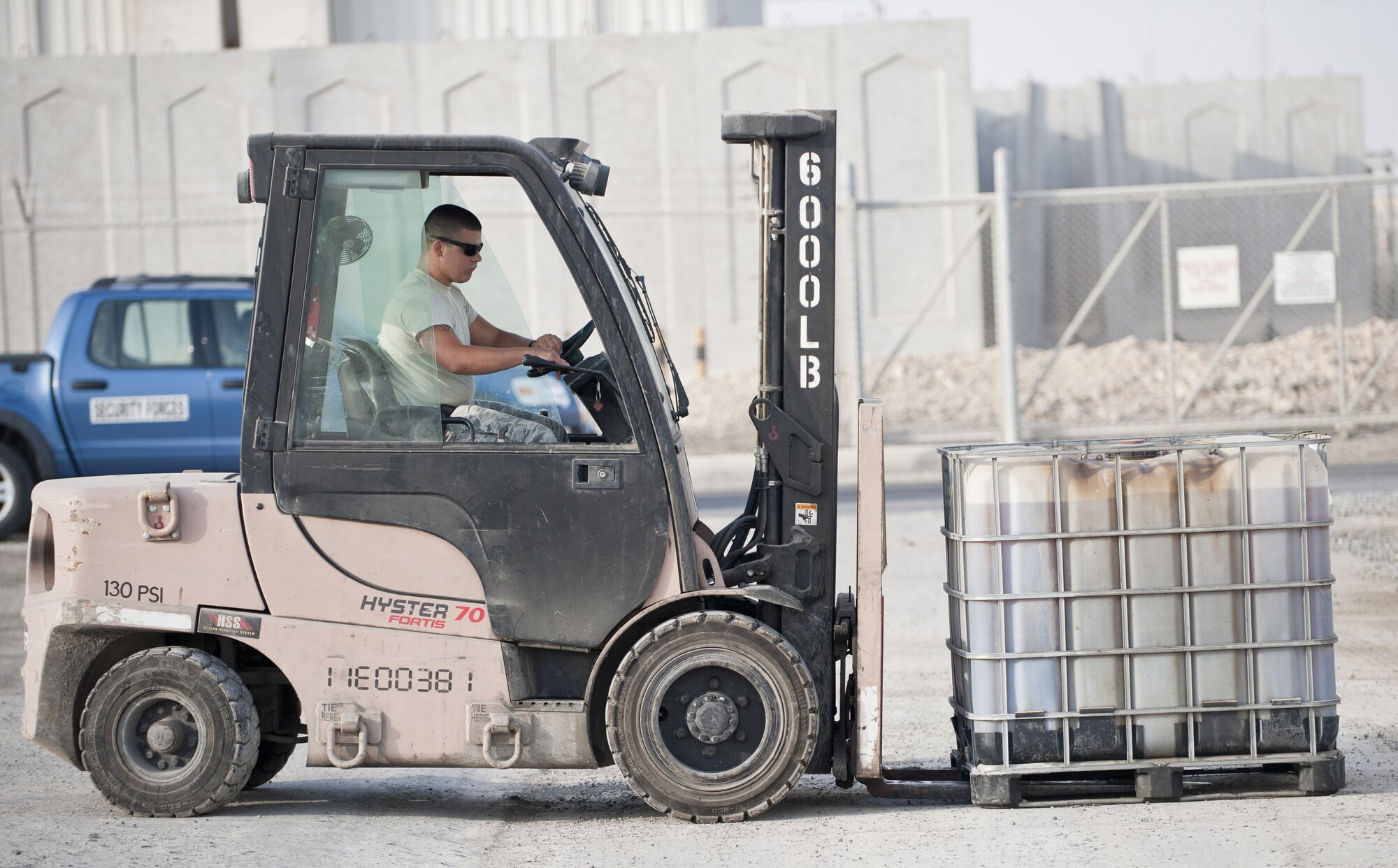 U.S. Air Force Airman 1st Class Mickey Laskowsky, 380th Expeditionary Force Support Squadron food services technician, uses a 6K forklift to lift a steel supported tub of cooking oil an at undisclosed location in Southwest Asia July 3, 2013. Laskowsky is the main forklift operator for the 380th EFSS where he uses it to deliver water to 58 different stops a day. He is originally from Pittsburgh, Penn., and is stationed with the 171st Air Refueling Wing with the Pennsylvania Air National Guard. (U.S. Air Force photo by Senior Airman Jacob Morgan)