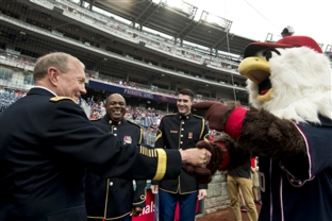 Army Gen. Martin E. Dempsey, chairman of the Joint Chiefs of Staff, shakes hands with Screech, the mascot of the Washington Nationals, before a game between the Nationals and Milwaukee Brewers at Nationals Park in Washington, D.C., July 4, 2013.