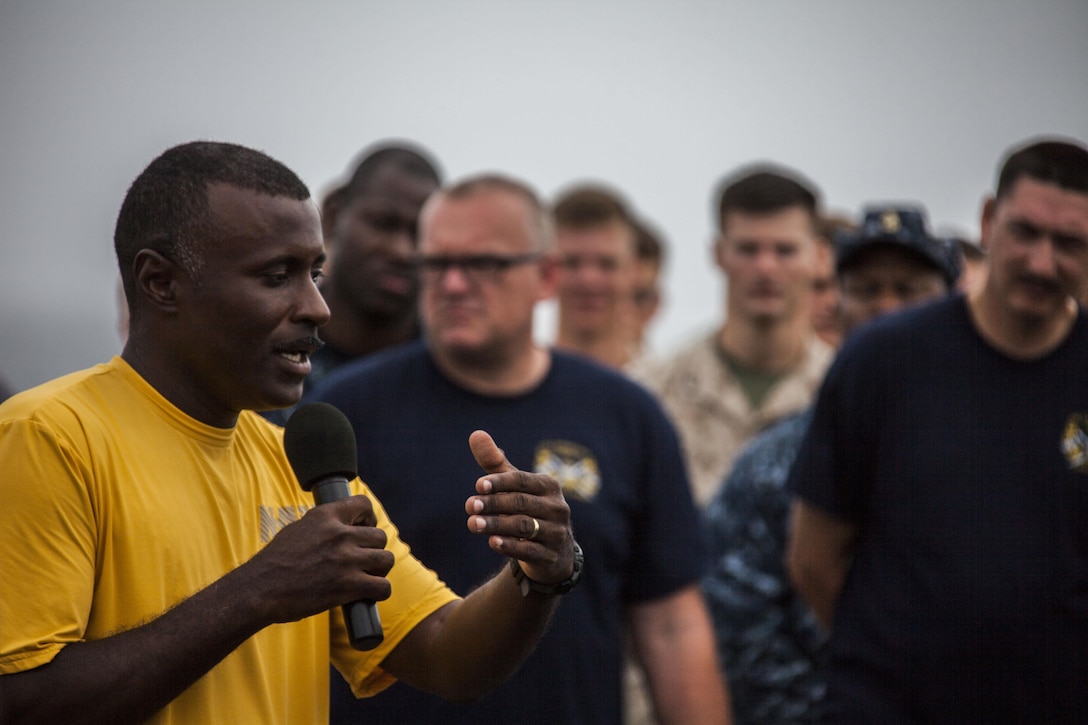 U.S. Navy Cmdr. Greg Blyden, commanding officer, USS Carter Hall (LSD 50), speaks to Marines and Sailors assigned to the 26th Marine Expeditionary Unit (MEU) and the USS Carter Hall aboard the ship while at sea July 4, 2013. The 26th MEU is a Marine Air-Ground Task Force forward-deployed to the U.S. 5th Fleet area of responsibility aboard the Kearsarge Amphibious Ready Group serving as a sea-based, expeditionary crisis response force capable of conducting amphibious operations across the full range of military operations. (U.S. Marine Corps photo by Staff Sgt. Edward Guevara/Released)