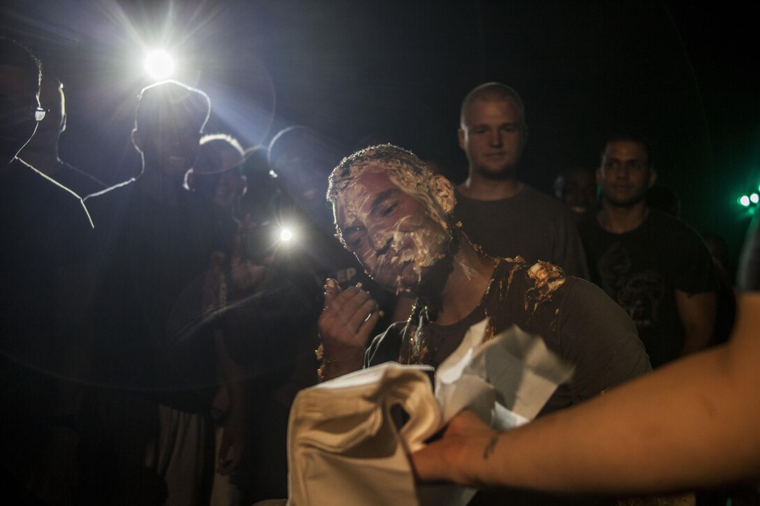 U.S. Marine Corps Capt. Raymond Kaster, Company K commanding officer, Battalion Landing Team 3/2, 26th Marine Expeditionary Unit (MEU), wipes pie off his face during the ship's Independence Day celebration aboard the USS Carter Hall (LSD 50) while at sea July 4, 2013. The 26th MEU is a Marine Air-Ground Task Force forward-deployed to the U.S. 5th Fleet area of responsibility aboard the Kearsarge Amphibious Ready Group serving as a sea-based, expeditionary crisis response force capable of conducting amphibious operations across the full range of military operations. (U.S. Marine Corps photo by Staff Sgt. Edward Guevara/Released)