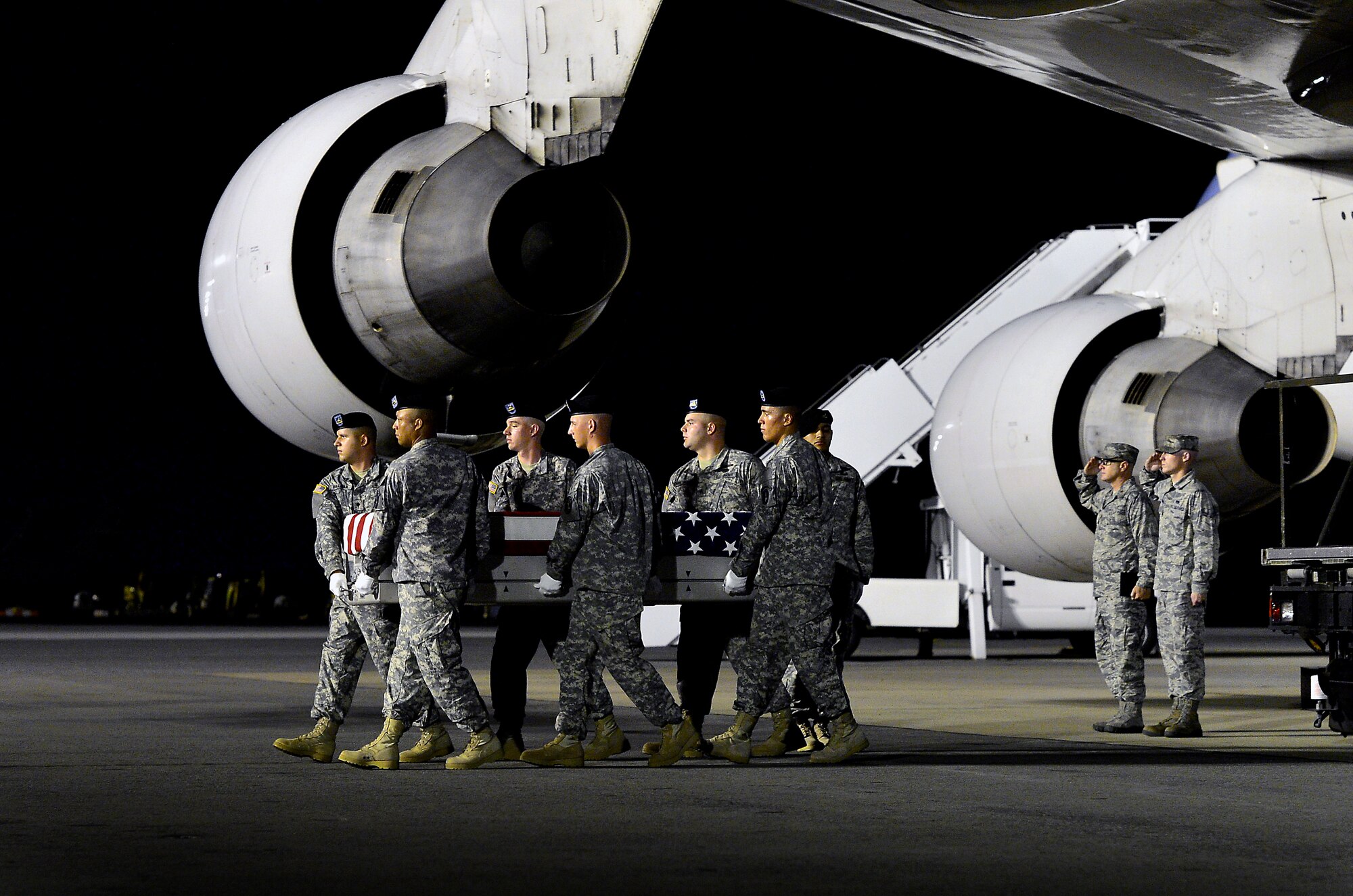A U.S. Army carry team transfers the remains of Pvt. Errol D. A. Milliard, of Birmingham, Ala., at Dover Air Force Base, Del., July 6, 2013. Milliard was assigned to the 2nd Engineer Battalion, 36th Engineer Brigade, White Sands Missile Range, N.M. (U.S. Air Force photo/David Tucker)
