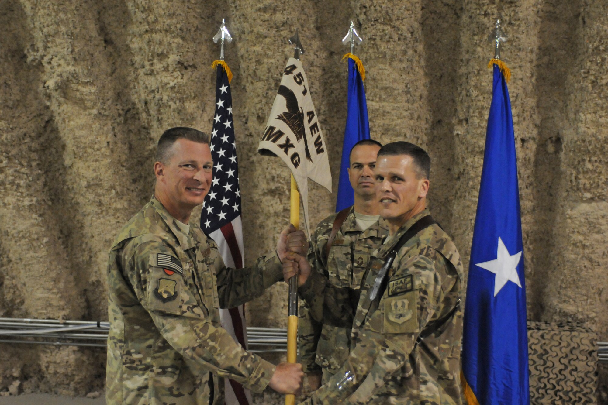 (From left) Brig. Gen. John Dolan, 451st Air Expeditionary Wing command, presents Col. Matthew Powell command of the 451st Expeditionary Maintenance Group during an assumption of command ceremony at Kandahar Airfield, Afghanistan, July 5. The 451st EMXG provides flightline, backshop and munitions support to tactical airlift, close air support, intelligence, surveillance and reconnaissance, command and control and airborne datalink aircraft. (U.S. Air Force photo/Capt. Brian Maguire)