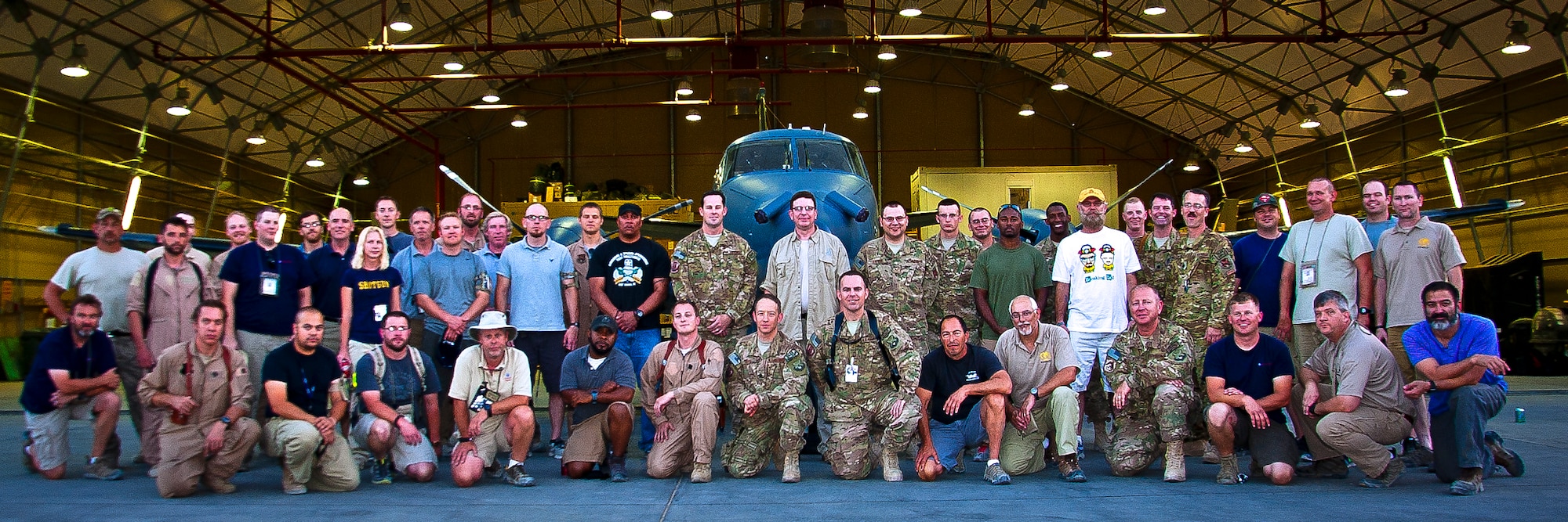 The 361st Expeditionary Reconnaissance Squadron Blue Devil team pose in front of their aircraft after completing their 4,000th sortie at Kandahar Airfield, Afghanistan. The Blue Devils are contractors providing a one-stop shop for an integrated intelligence capability to Coalition forces. (U.S. Air Force photo/Senior Airman Scott Saldukas)