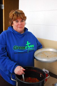 Family Readiness Group President Cindy Shanks shows off some home made vegetable soup to Soldiers at the 307th Maintenance Company Armory. She cooked the meal on a friend's gas stove to bring to Soldiers during the January ice storm.