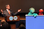 Gary Knell, president and CEO of Sesame Workshop and Sesame Street's Elmo and Rosita, speaks with Elmo and Rosita during the screening of "Coming Home: Military Families Cope with Change," a Sesame Street special, at the Pentagon, March 18, 2009. Sesame Workshop, a nonprofit educational organization, has spent the past two years creating materials to help military families with young children cope with deployments, homecomings and changes.