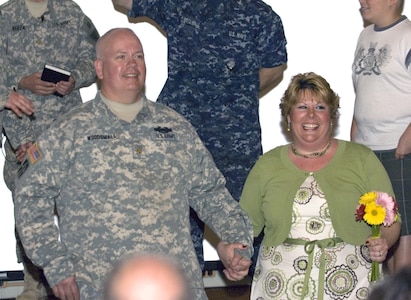 Maj. Mark Woodsmall and his new bride, Beth, greet their wedding guests for the first time as husband and wife. The couple was married early April in the chapel at Muscatatuck Urban Training Center in Butlerville, Ind. Woodsmall was attending weekend training with the 38th Infantry Division's Special Troops Battalion in preparation for deployment to Afghanistan.