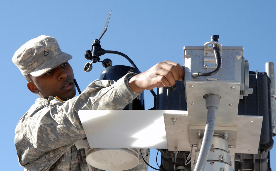 COLORADO SPRINGS, Colo. - Army Pfc. Aaron Garlington, 206th Army Liaison Team, sets up a portable cell phone tower and weather station during the Coalition Warrior Interoperability Demonstration June 15. CWID allows the military to test emerging technologies in an operational setting. U.S. Northern Command, in cooperation with the city of Colorado Springs, tested the new equipment in a scenario where terrorists destroyed several cell phone towers, and temporary communications needed to be reestablished quickly. (U.S. Air Force photo by Staff Sgt. Thomas J. Doscher) 